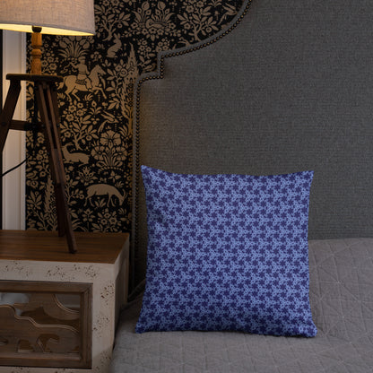 18″×18″ throw pillow with the 'Trigon' navy and blue geometric pattern on a bed.