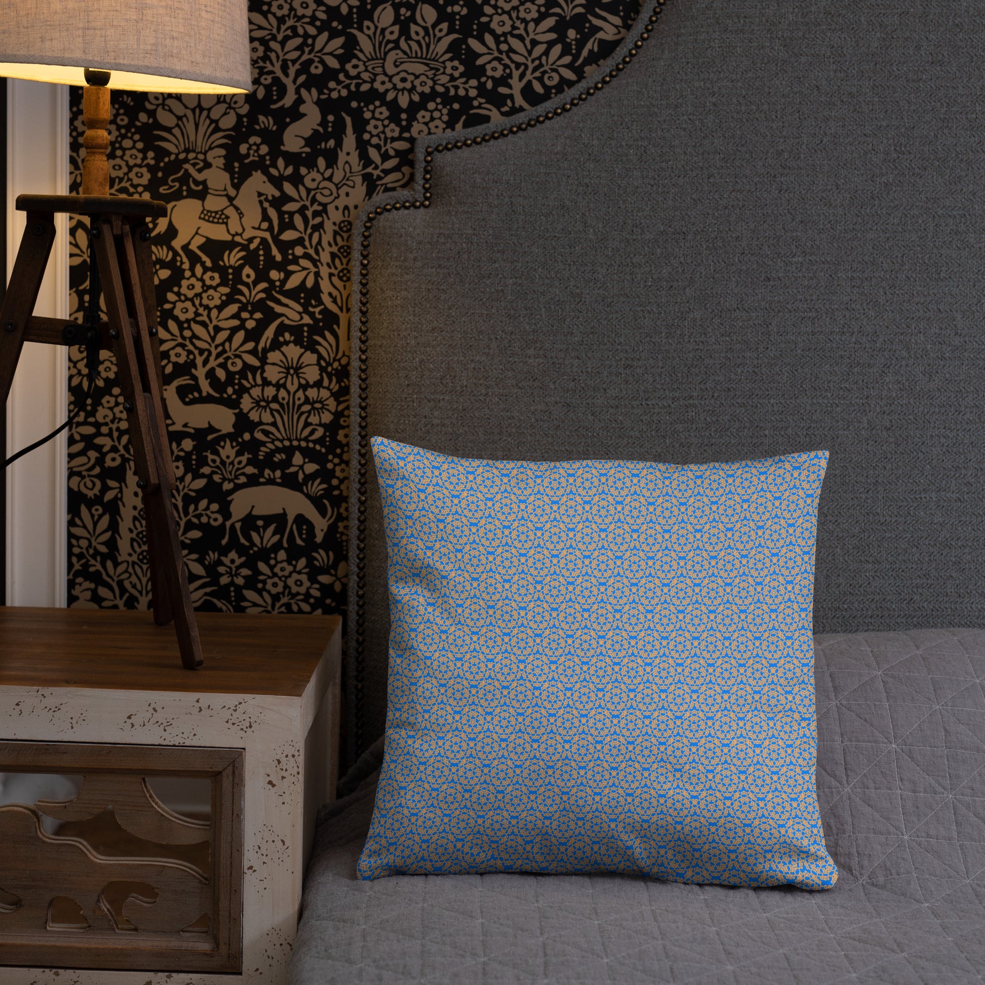 18″×18″ throw pillow with the 'Pentagon' blue and yellow geometric pattern on a bed.