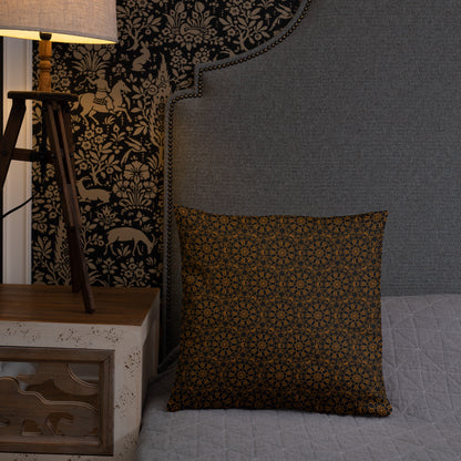 18″×18″ throw pillow with the 'Enneagon' black & gold geometric pattern on a bed with upholstered headboard.