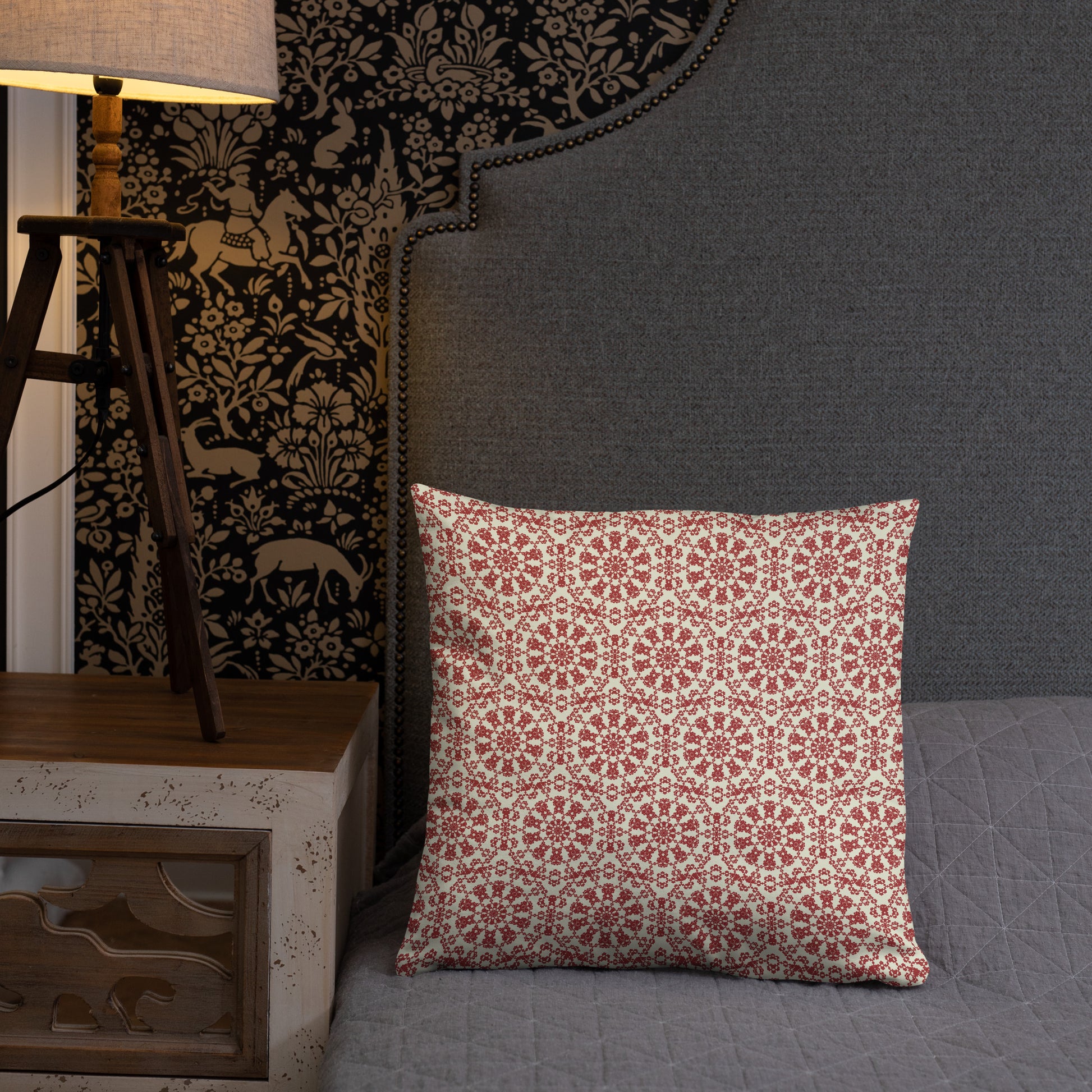 18″×18″ throw pillow with the ‘Decagon’ terracotta and beige geometric pattern on a grey bed with an ornate headboard.