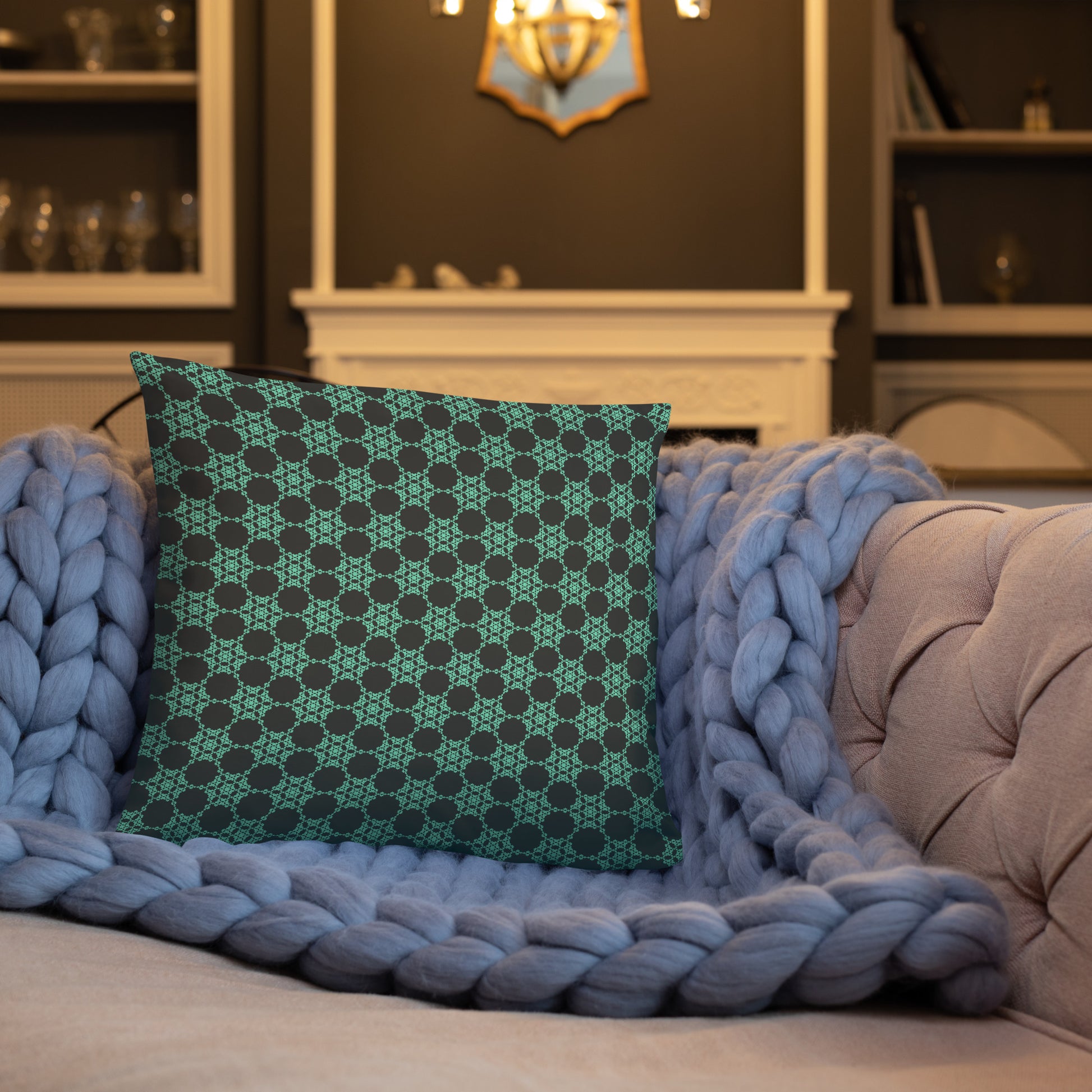 18″×18″ throw pillow with the 'Flowers Victory' charcoal and mint geometric pattern on a sofa.
