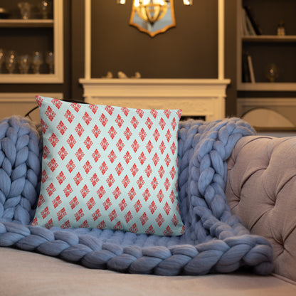 18″×18″ throw pillow with the 'Digon' sky blue and red geometric pattern on a sofa.