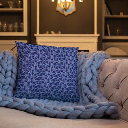 18″×18″ throw pillow with the 'Trigon' navy and blue geometric pattern on a sofa.