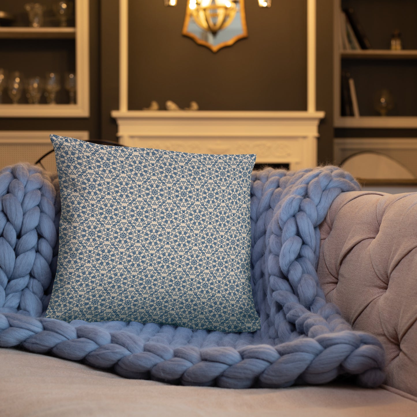 18″×18″ throw pillow with the ‘Octagon’ navy and beige geometric pattern on a sofa with chunky knit blanket.