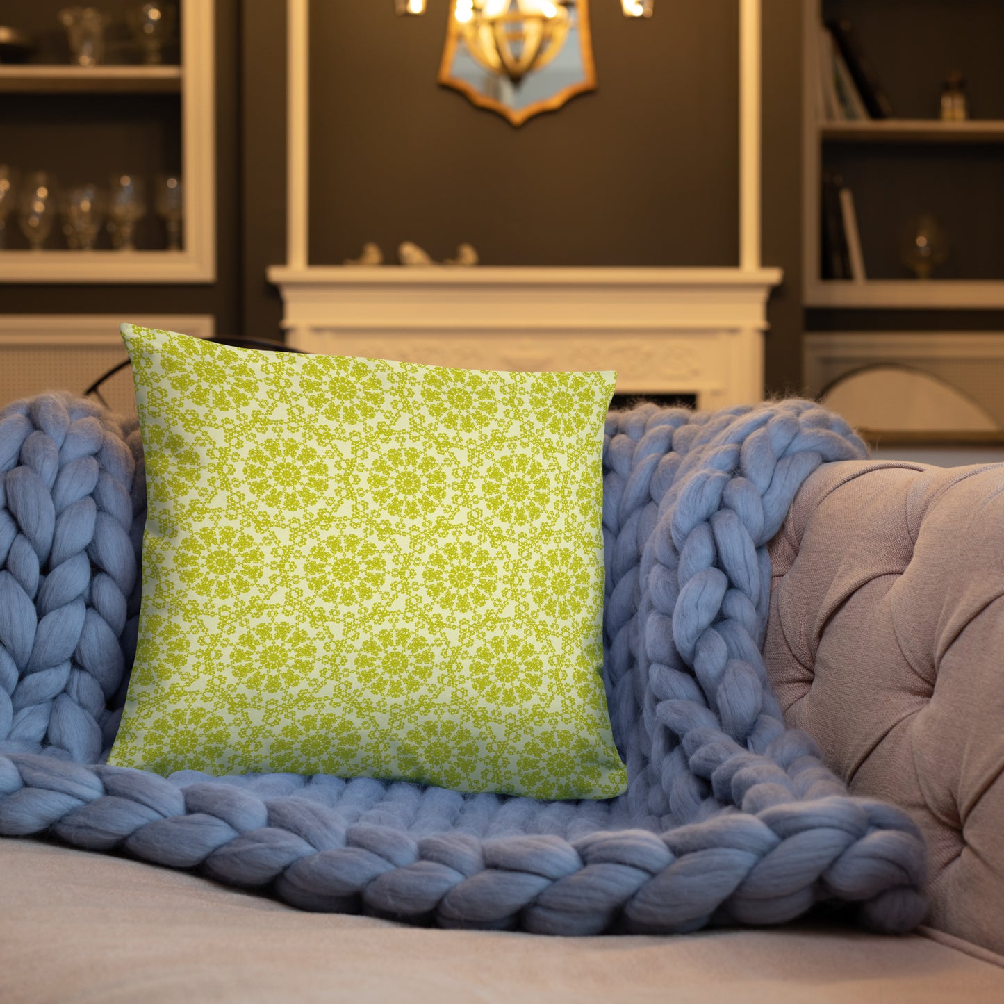 18″×18″ throw pillow with the 'Hendecagon' yellow-green geometric pattern on a sofa with chunky knit blanket