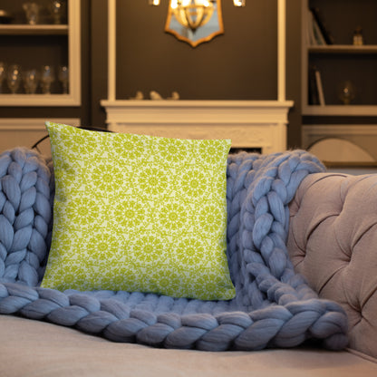 18″×18″ throw pillow with the 'Hendecagon' yellow-green geometric pattern on a sofa with chunky knit blanket