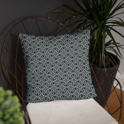 18″×18″ throw pillow with the 'Tetragon' charcoal and white geometric pattern on a chair.
