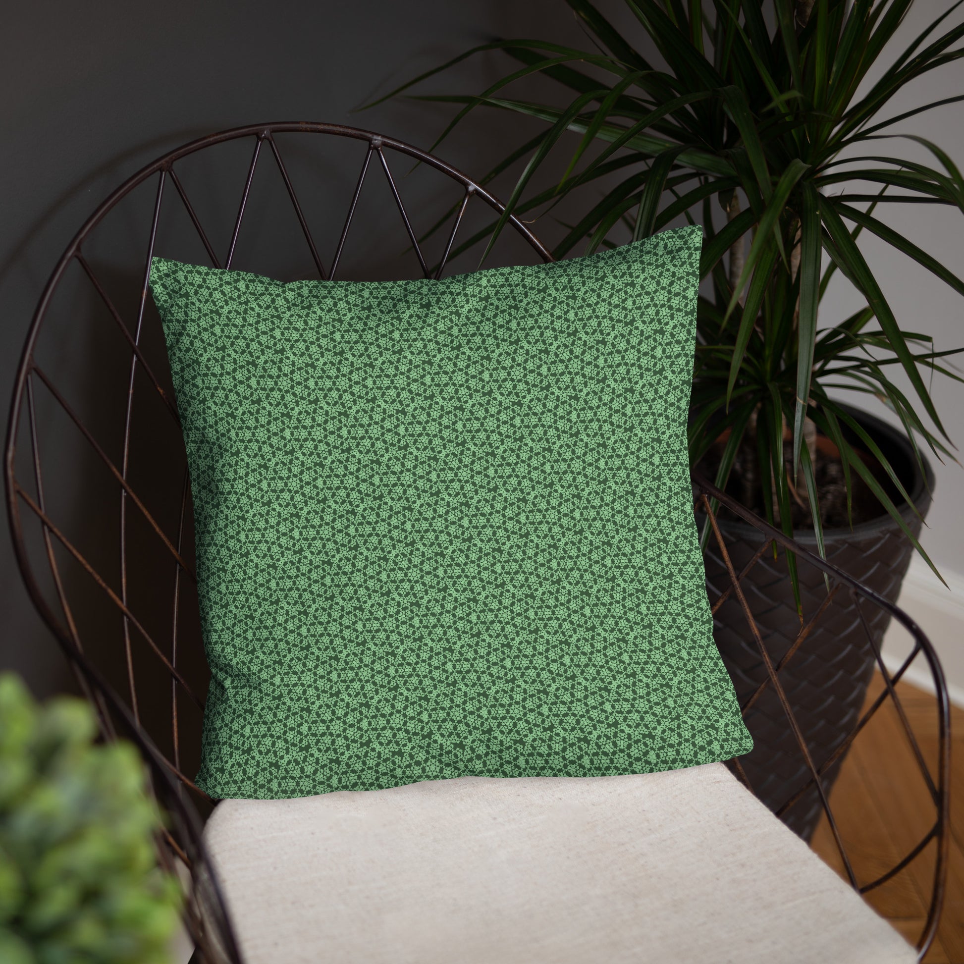 18″×18″ throw pillow with the 'Heptagon' green geometric pattern on a chair.