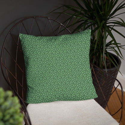 18″×18″ throw pillow with the 'Heptagon' green geometric pattern on a chair.