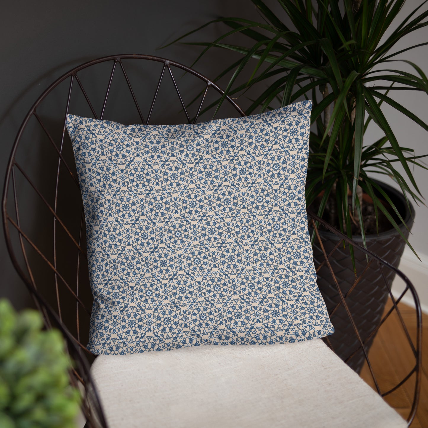 18″×18″ throw pillow with the ‘Octagon’ navy and beige geometric pattern on a wire chair.