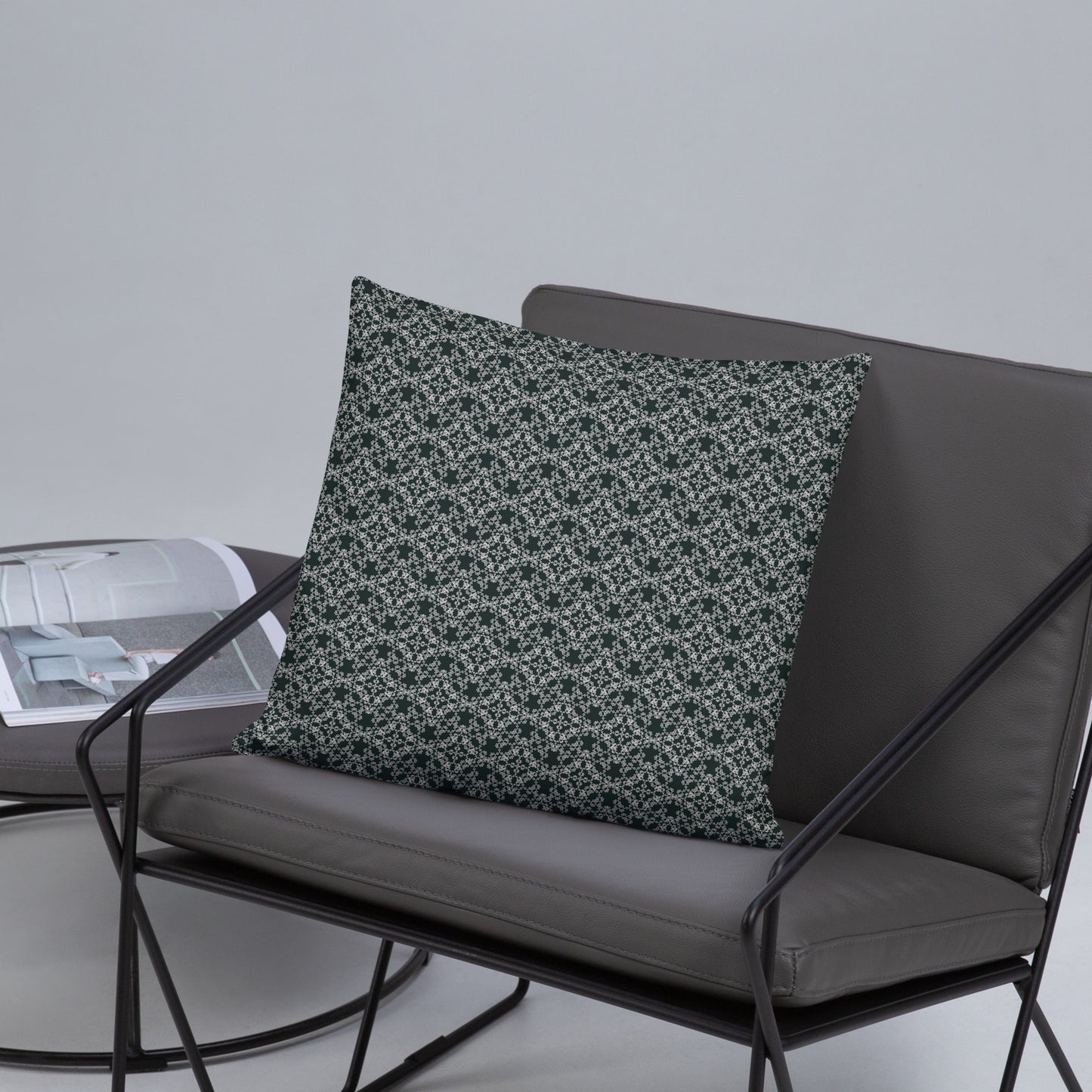 Front of the 18″×18″ basic pillow with the 'Quadragon' charcoal and white fractal geometric pattern on a chair.