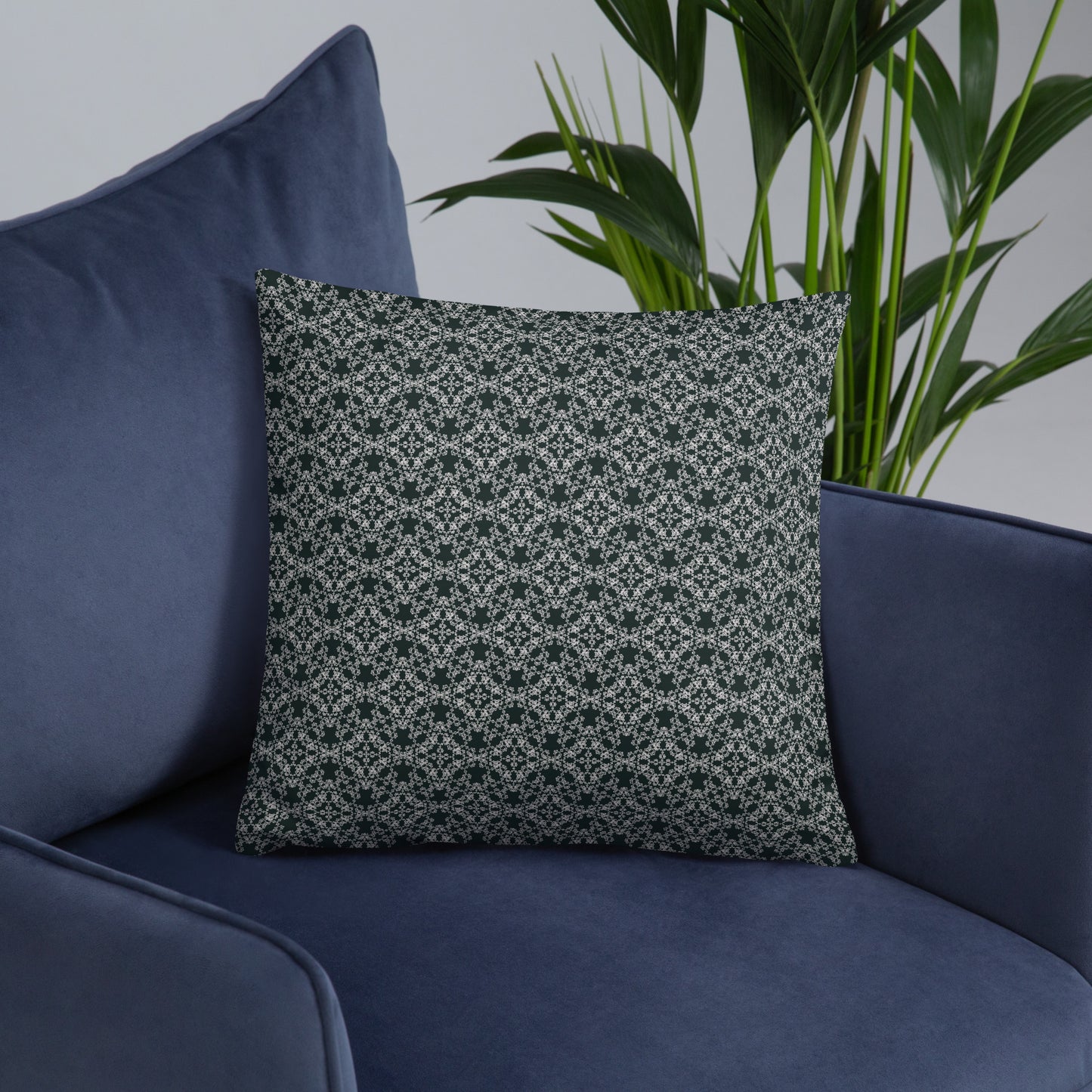 Front of the 18″×18″ basic pillow with the 'Quadragon' charcoal and white fractal geometric pattern on an armchair.