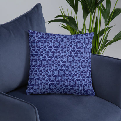 18″×18″ throw pillow with the 'Trigon' navy and blue geometric pattern on an armchair.