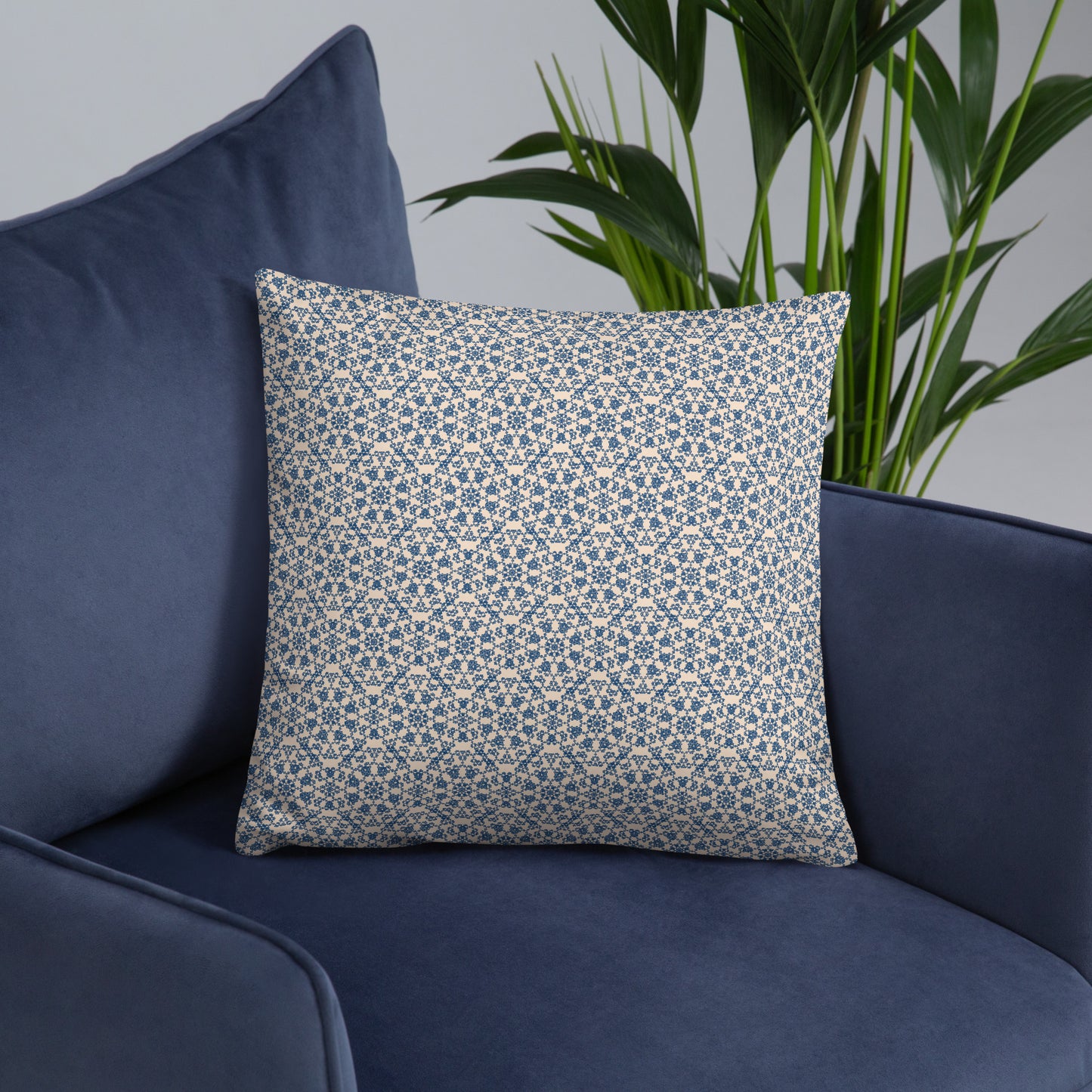 18″×18″ throw pillow with the ‘Octagon’ navy and beige geometric pattern on a navy sofa.