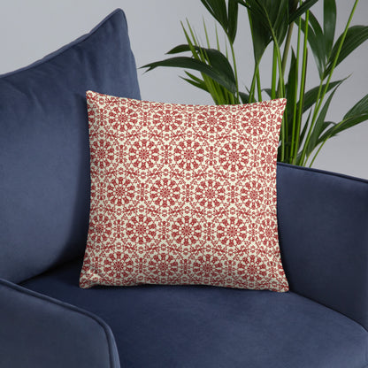 18″×18″ throw pillow with the ‘Decagon’ terracotta and beige geometric pattern on a navy blue armchair.