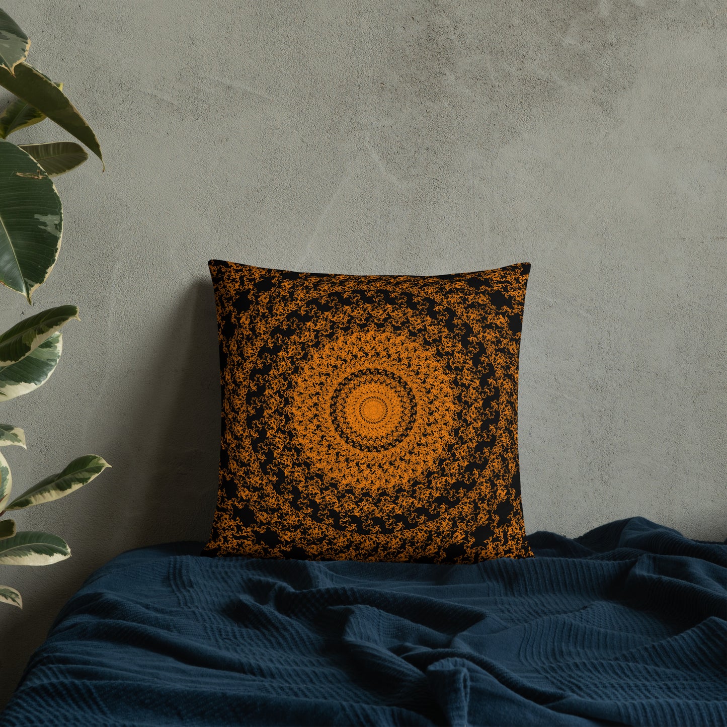 18″×18″ throw pillow with the 'The Sun' orange and black geometric design on a bed.