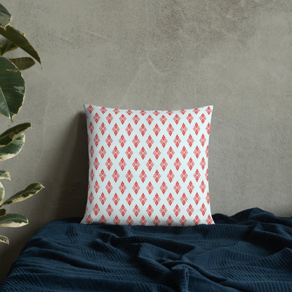 18″×18″ throw pillow with the 'Digon' sky blue and red geometric pattern on a bed.