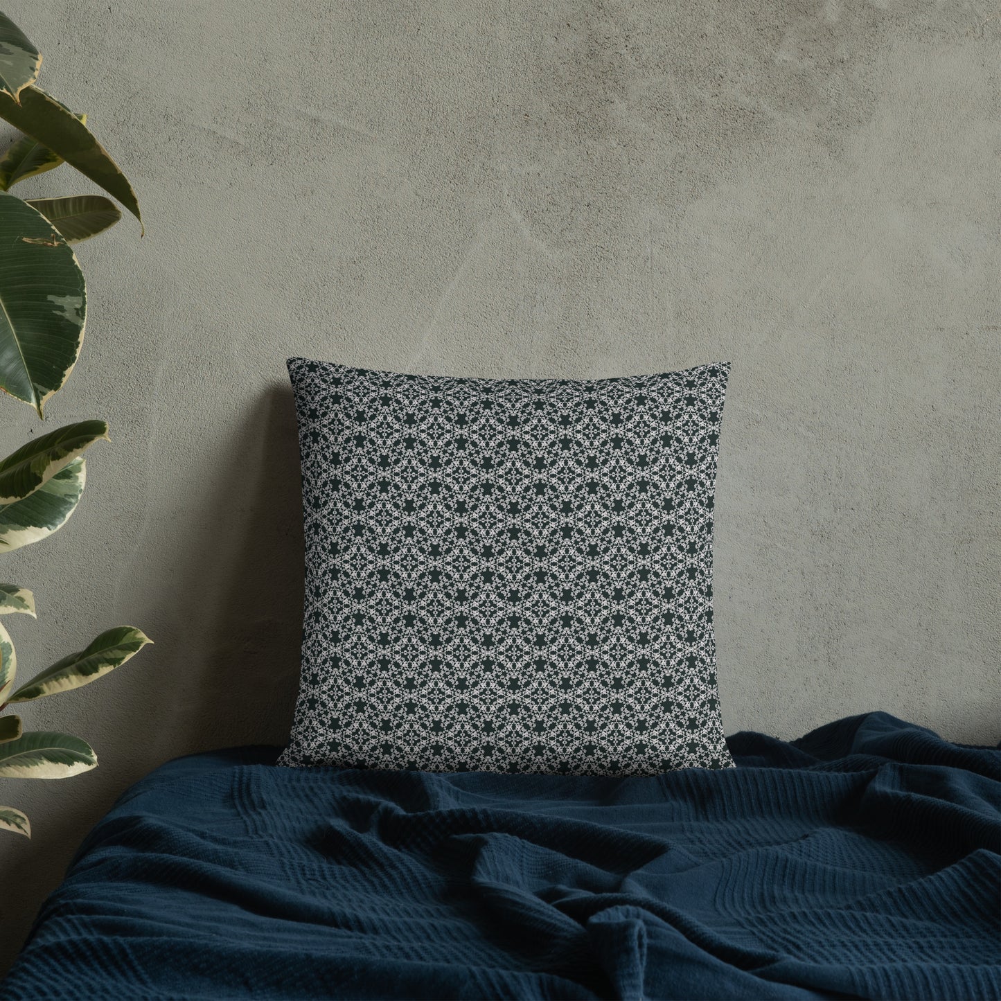 18″×18″ throw pillow with the 'Tetragon' charcoal and white geometric pattern on a bed.