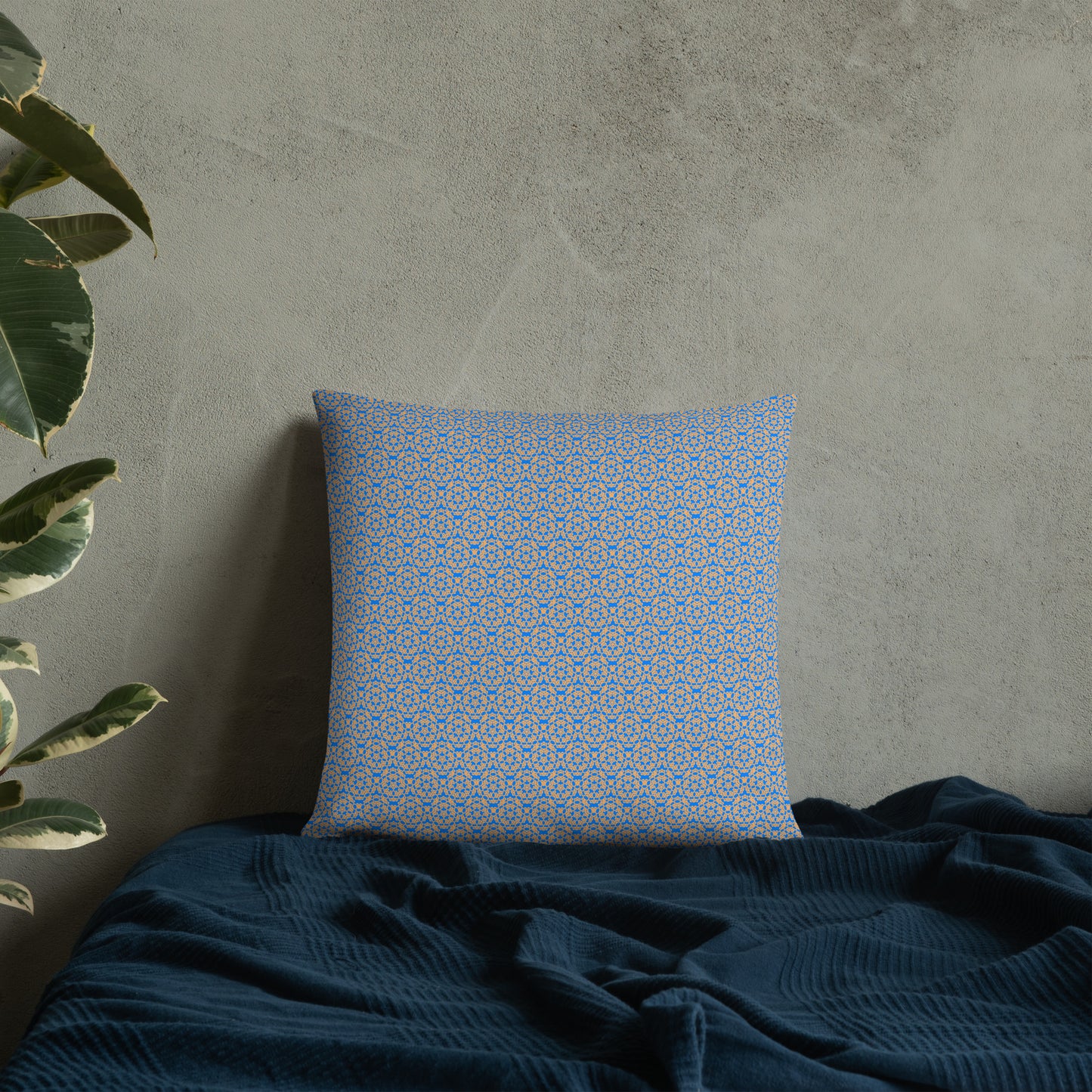 18″×18″ throw pillow with the 'Pentagon' blue and yellow geometric pattern on a bed.