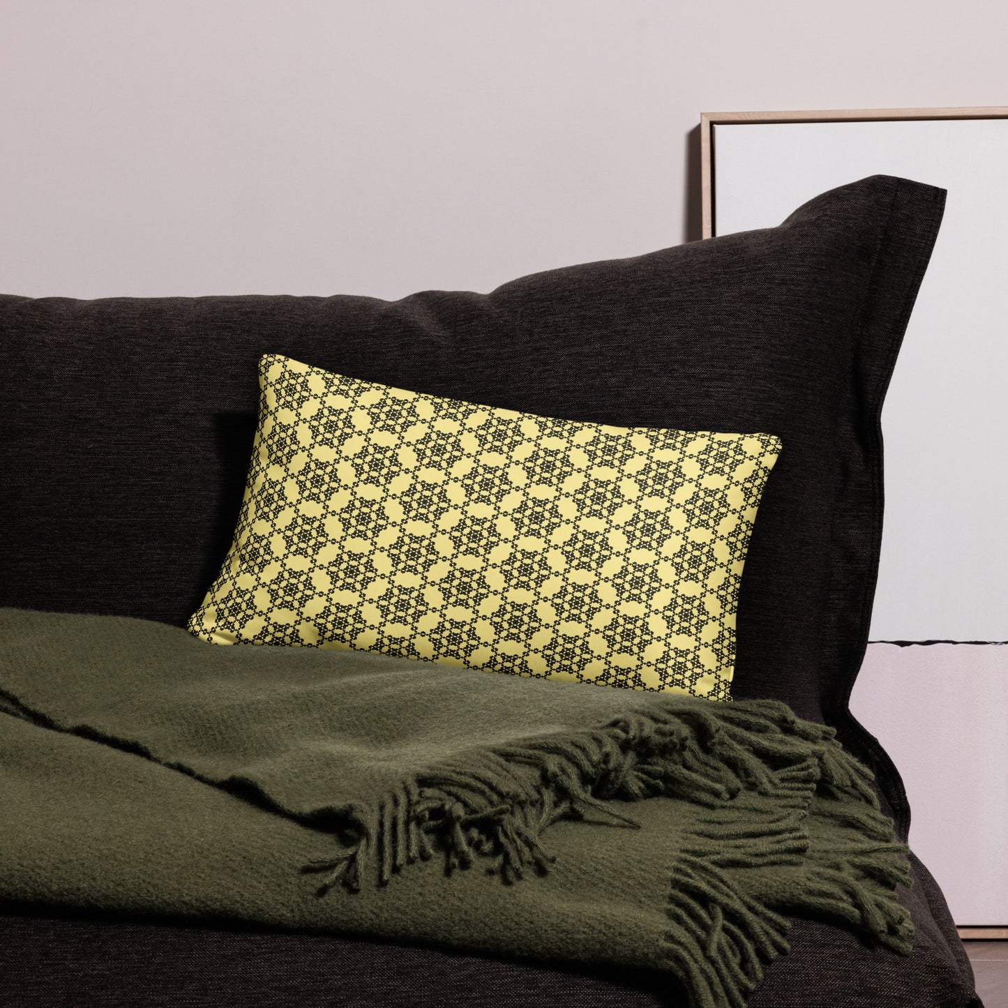 20″×12″ throw pillow with the 'Hexagon' yellow and black geometric pattern on a couch.