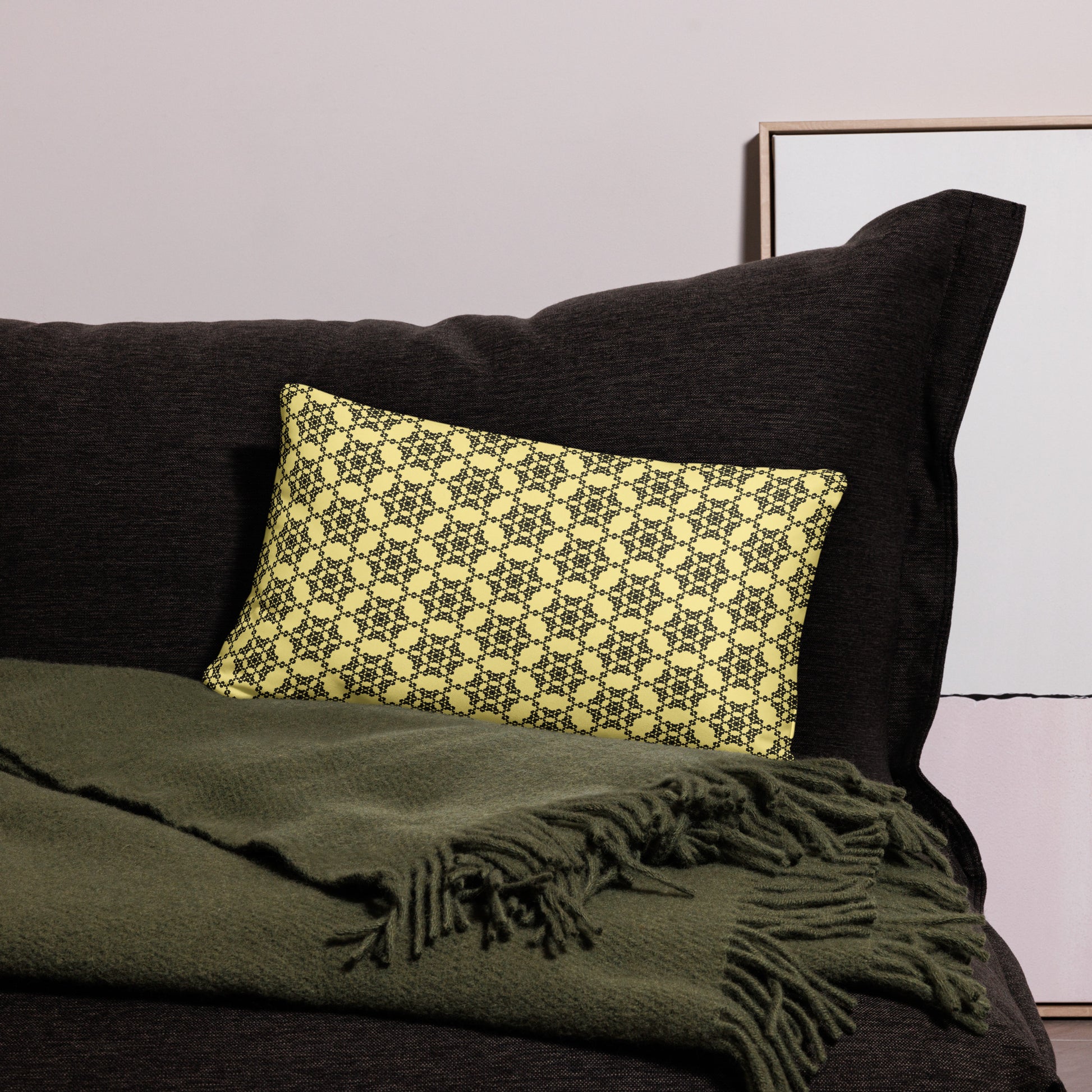 20″×12″ throw pillow with the 'Hexagon' yellow and black geometric pattern on a couch.