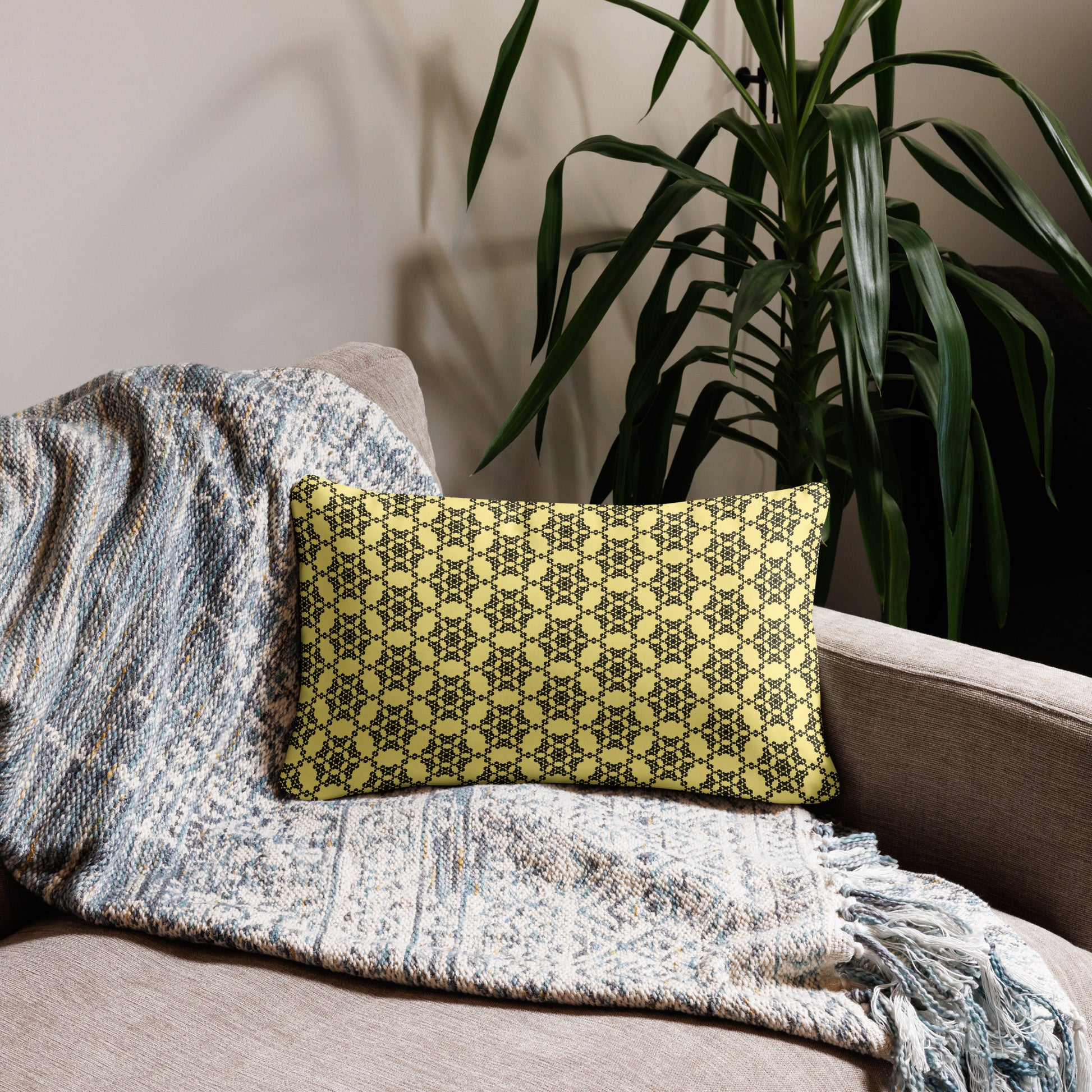 20″×12″ throw pillow with the 'Hexagon' yellow and black geometric pattern on a couch.