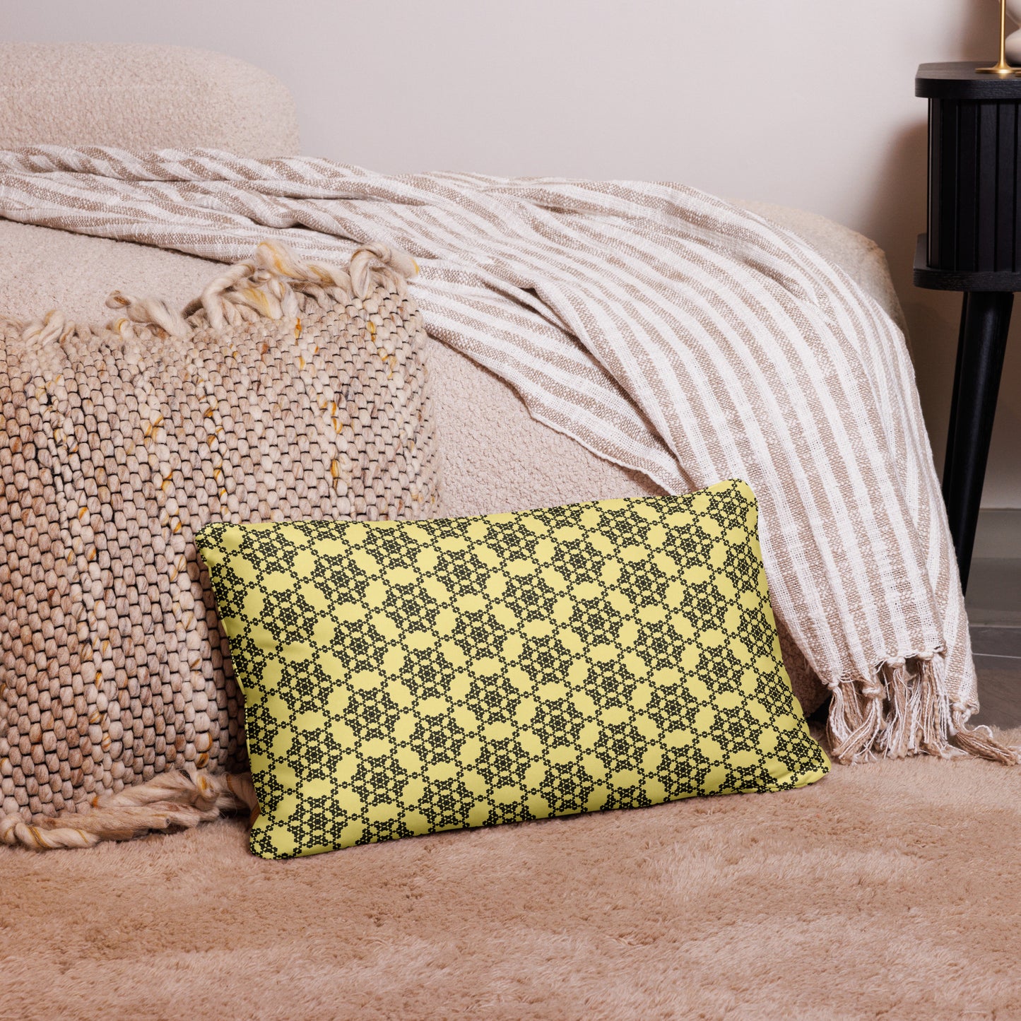 20″×12″ throw pillow with the 'Hexagon' yellow and black geometric pattern on a couch.