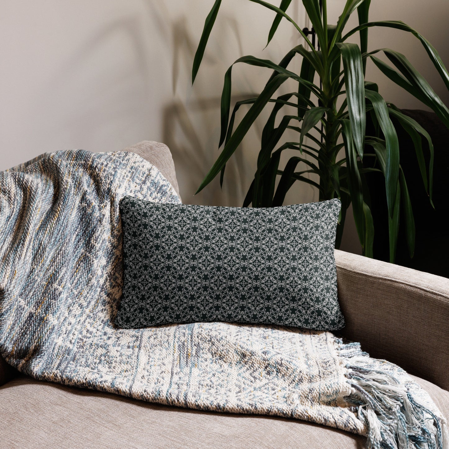 20″×12″ throw pillow with the 'Tetragon' charcoal and white geometric pattern on a couch.