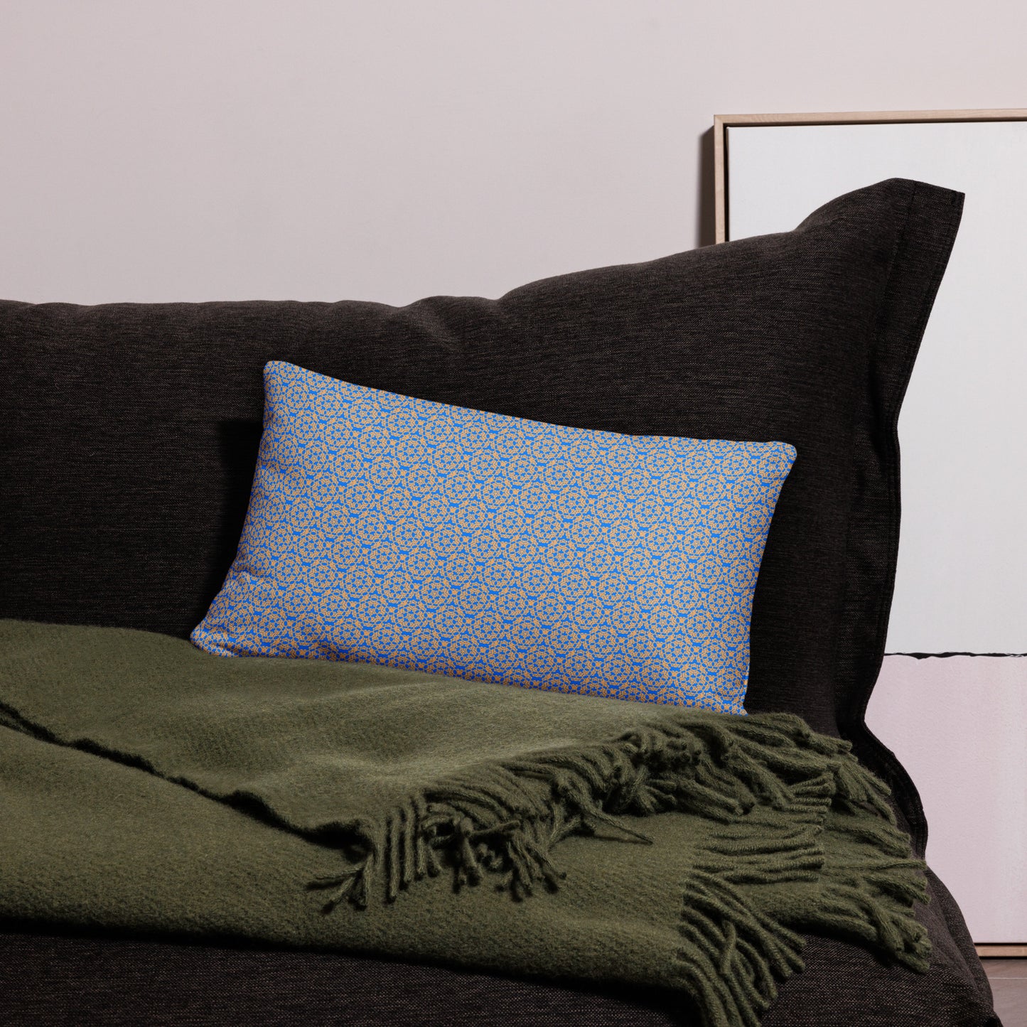 20″×12″ throw pillow with the 'Pentagon' blue and yellow geometric pattern on a couch.