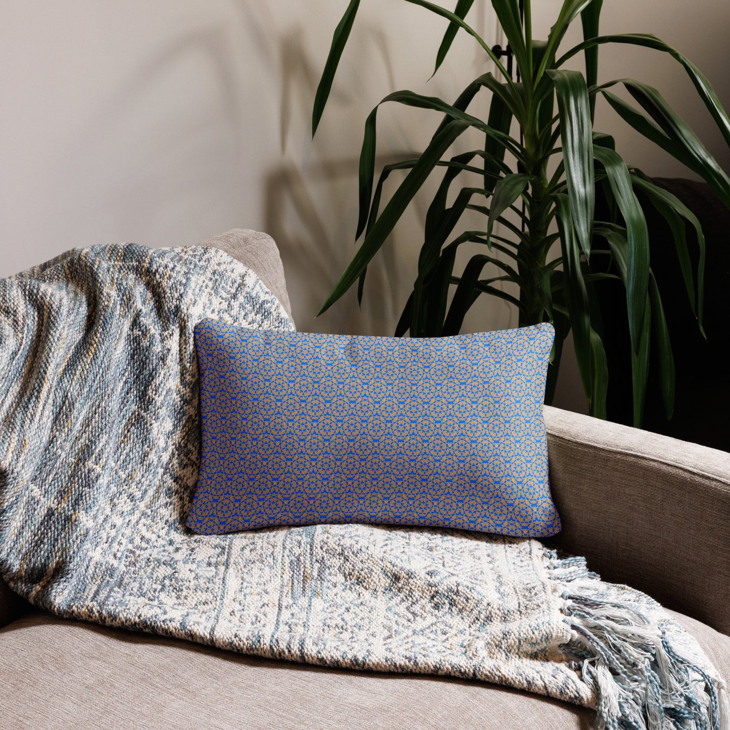 20″×12″ throw pillow with the 'Pentagon' blue and yellow geometric pattern on a couch.