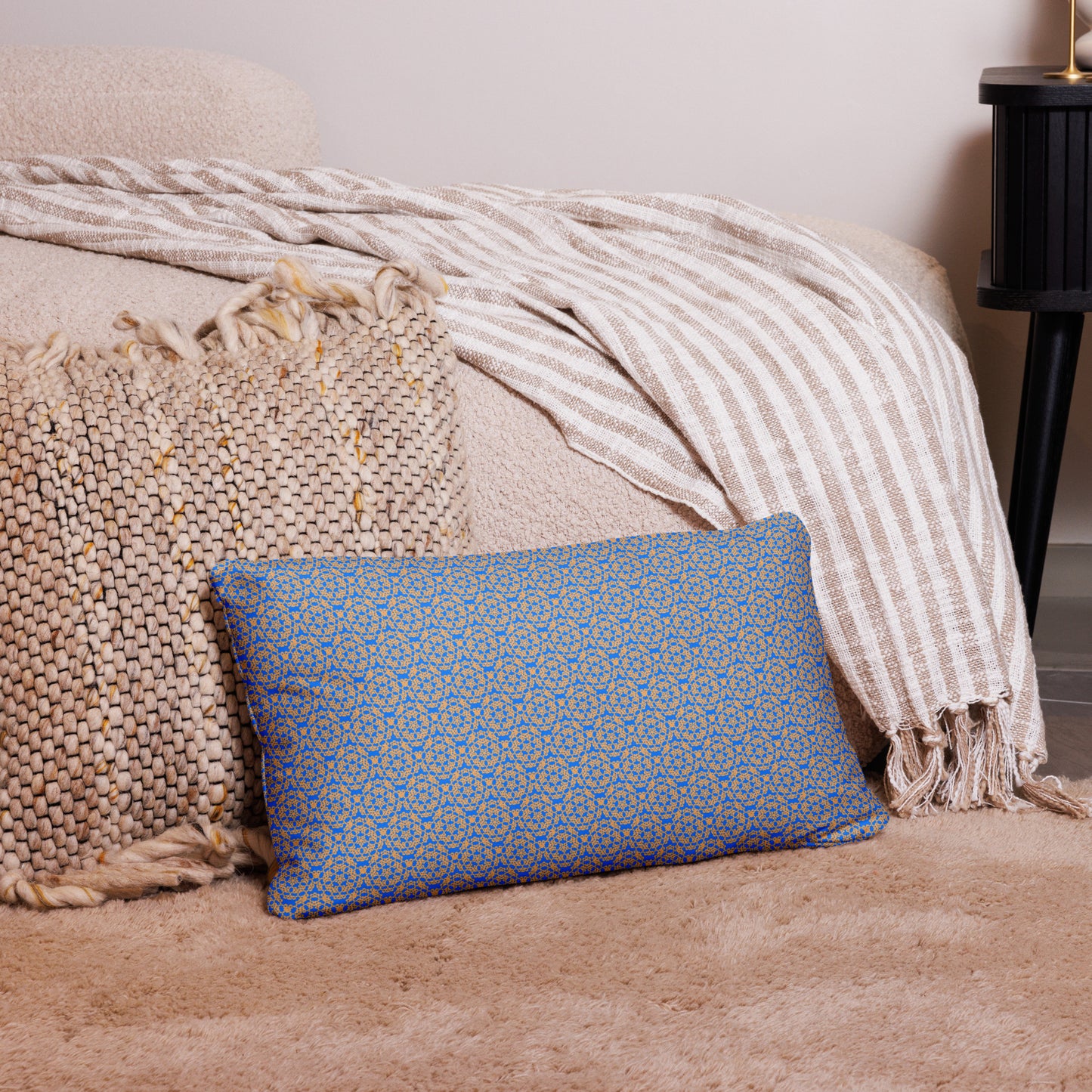 20″×12″ throw pillow with the 'Pentagon' blue and yellow geometric pattern on a couch.