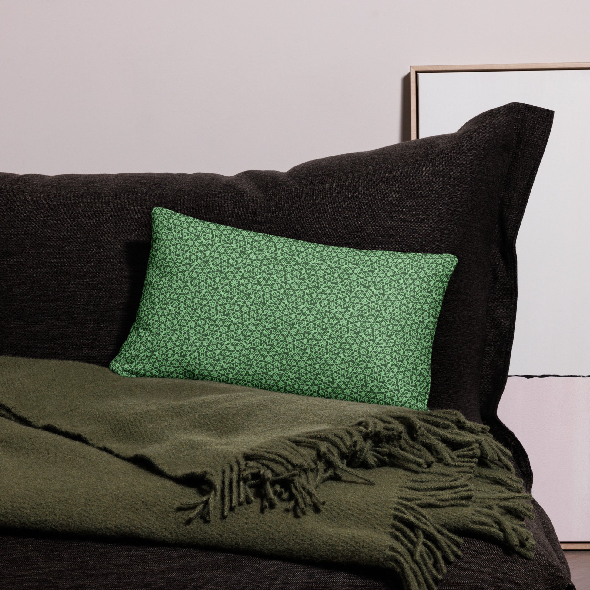 20″×12″ throw pillow with the 'Heptagon' green geometric pattern on a couch.