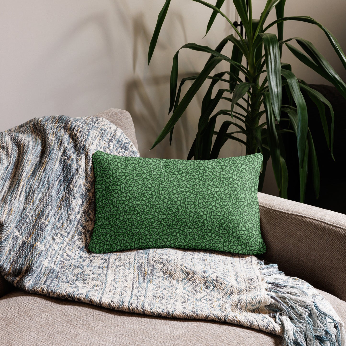 20″×12″ throw pillow with the 'Heptagon' green geometric pattern on a couch.