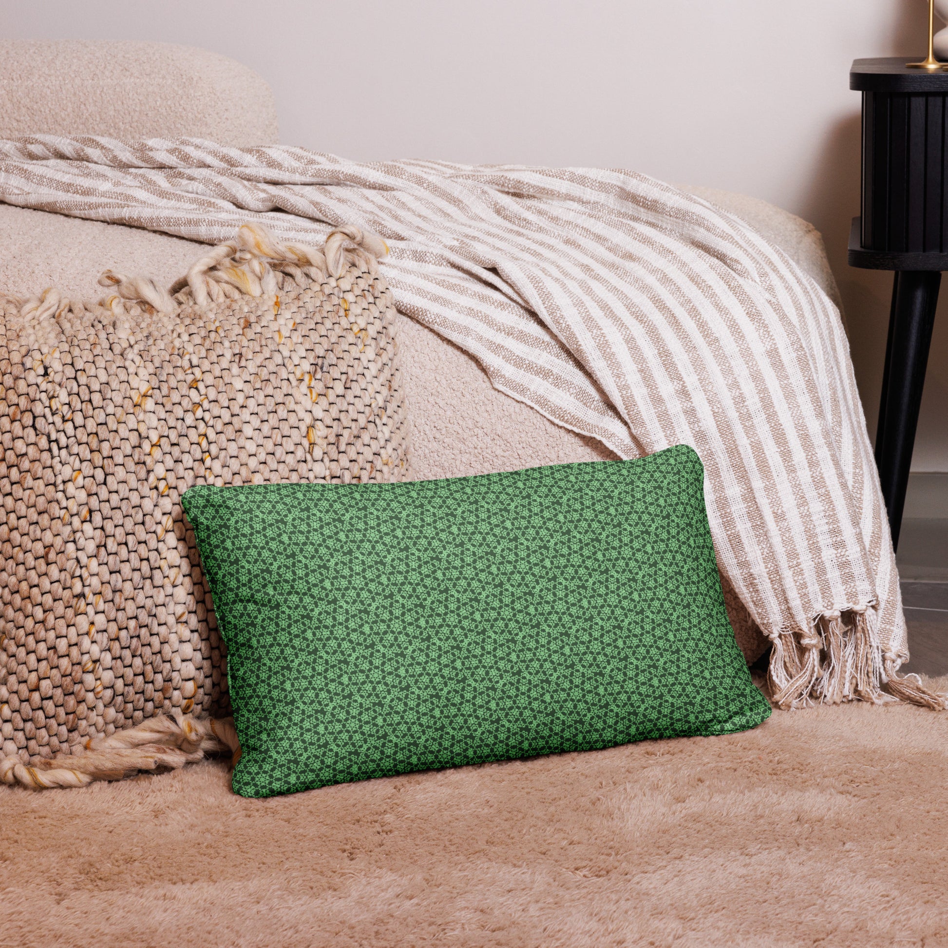 20″×12″ throw pillow with the 'Heptagon' green geometric pattern on a couch.