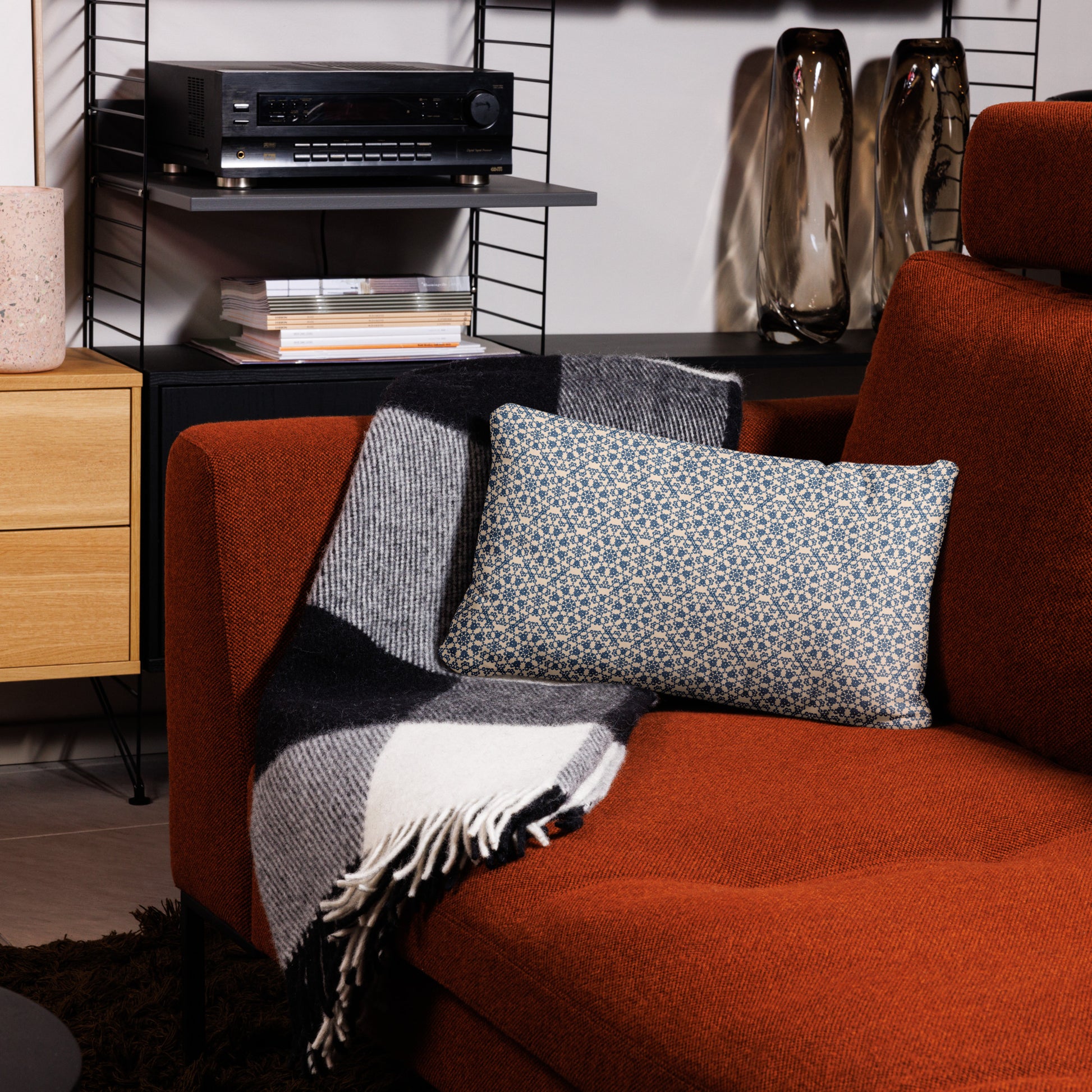 20″×12″ throw pillow with the ‘Octagon’ navy and beige geometric pattern on an armchair.