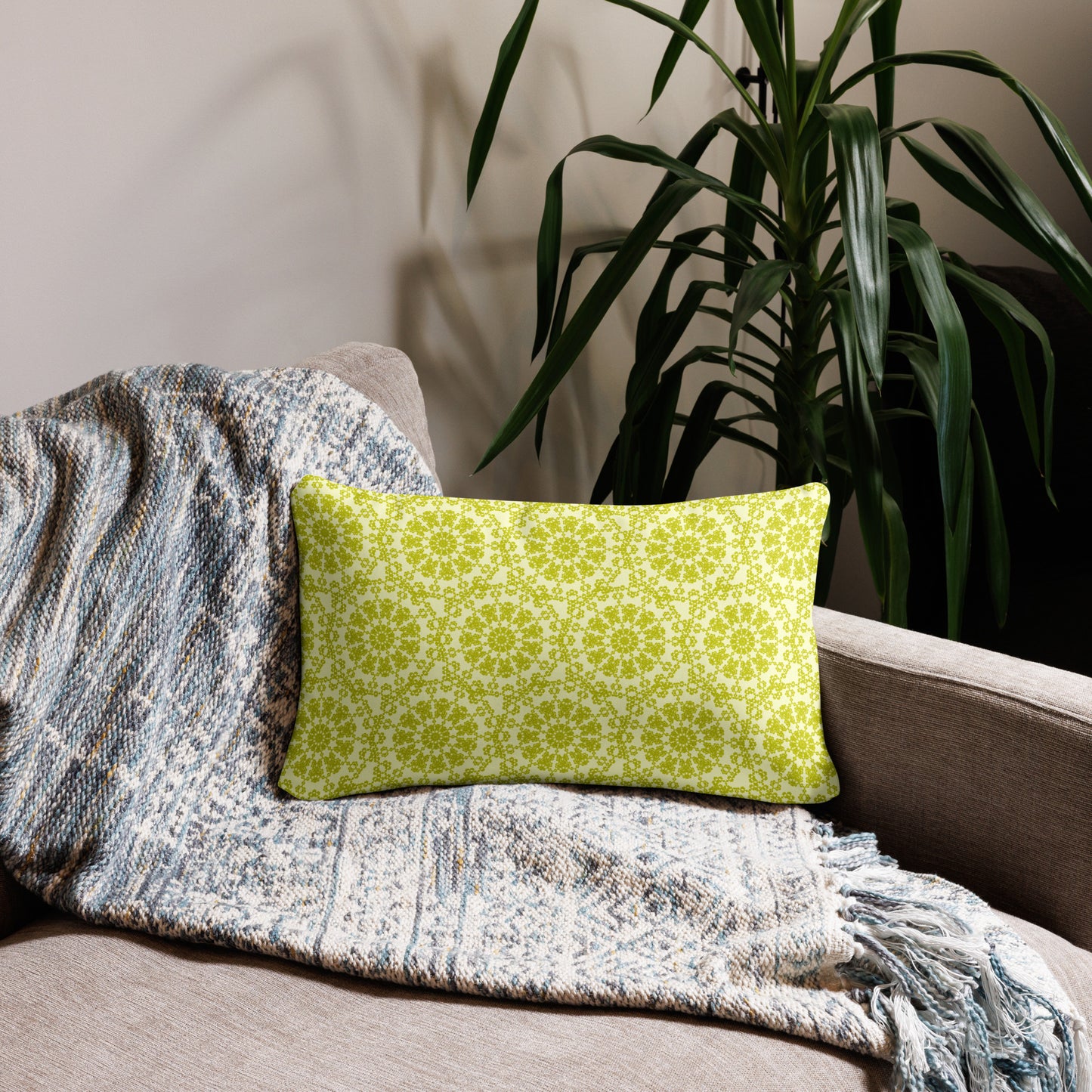 20″×12″ throw pillow with the 'Hendecagon' yellow-green geometric pattern on a beige sofa with woven throw