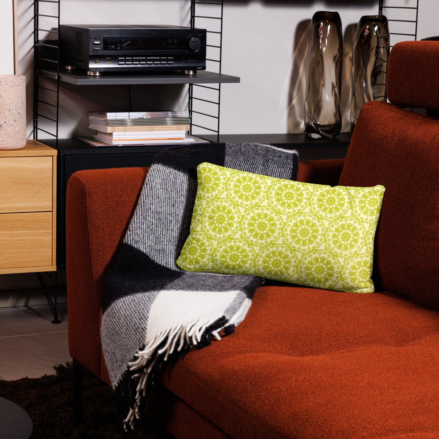 20″×12″ throw pillow with the 'Hendecagon' yellow-green geometric pattern on a terracotta sofa in a modern living room