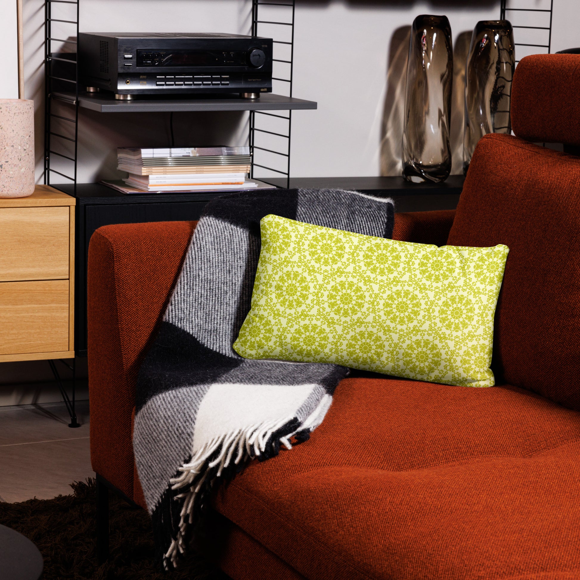 20″×12″ throw pillow with the 'Hendecagon' yellow-green geometric pattern on a terracotta sofa in a modern living room