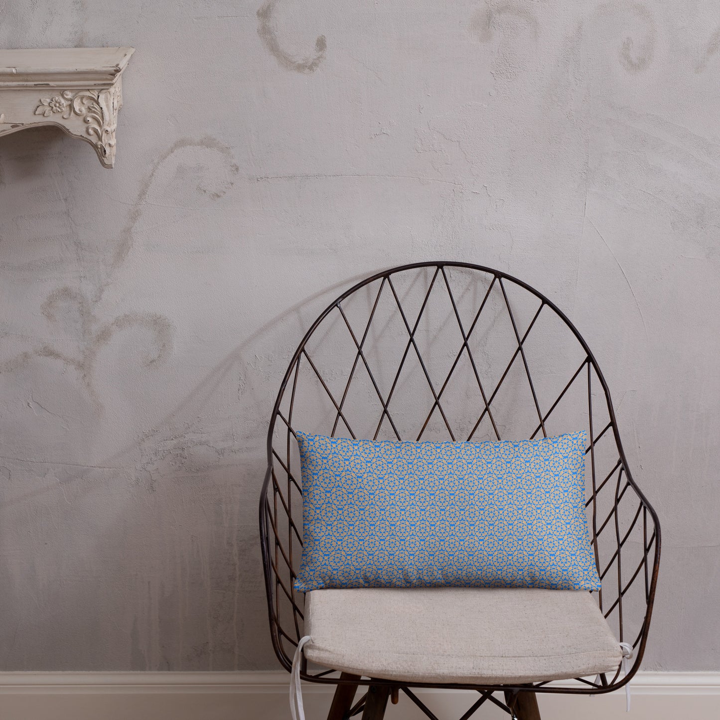 20″×12″ throw pillow with the 'Pentagon' blue and yellow geometric pattern on a chair.