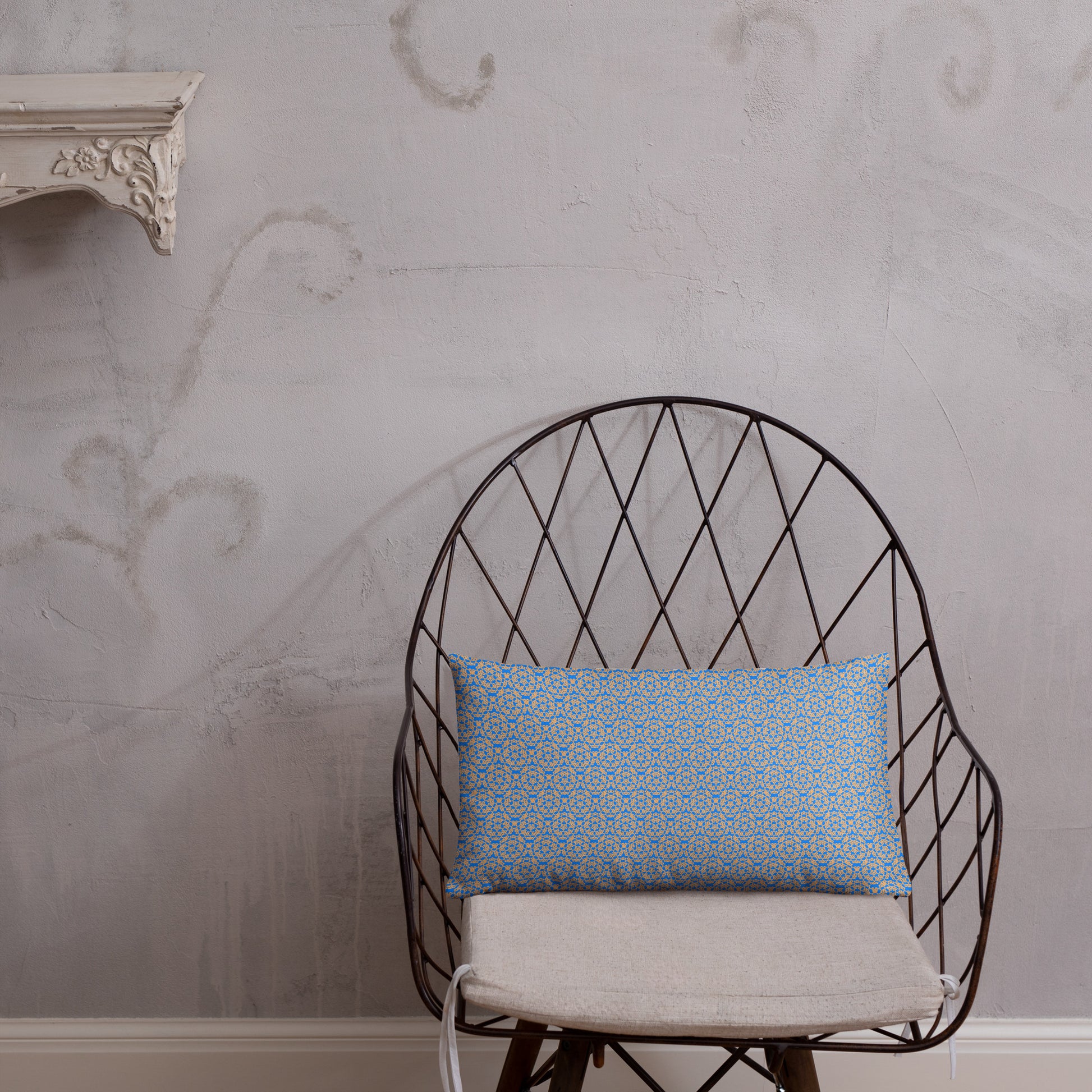 20″×12″ throw pillow with the 'Pentagon' blue and yellow geometric pattern on a chair.