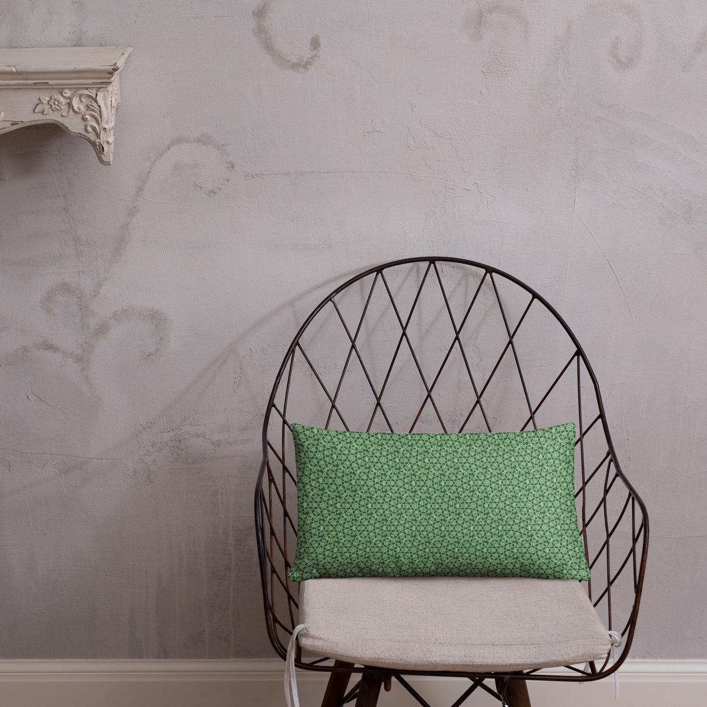 20″×12″ throw pillow with the 'Heptagon' green geometric pattern on a chair.