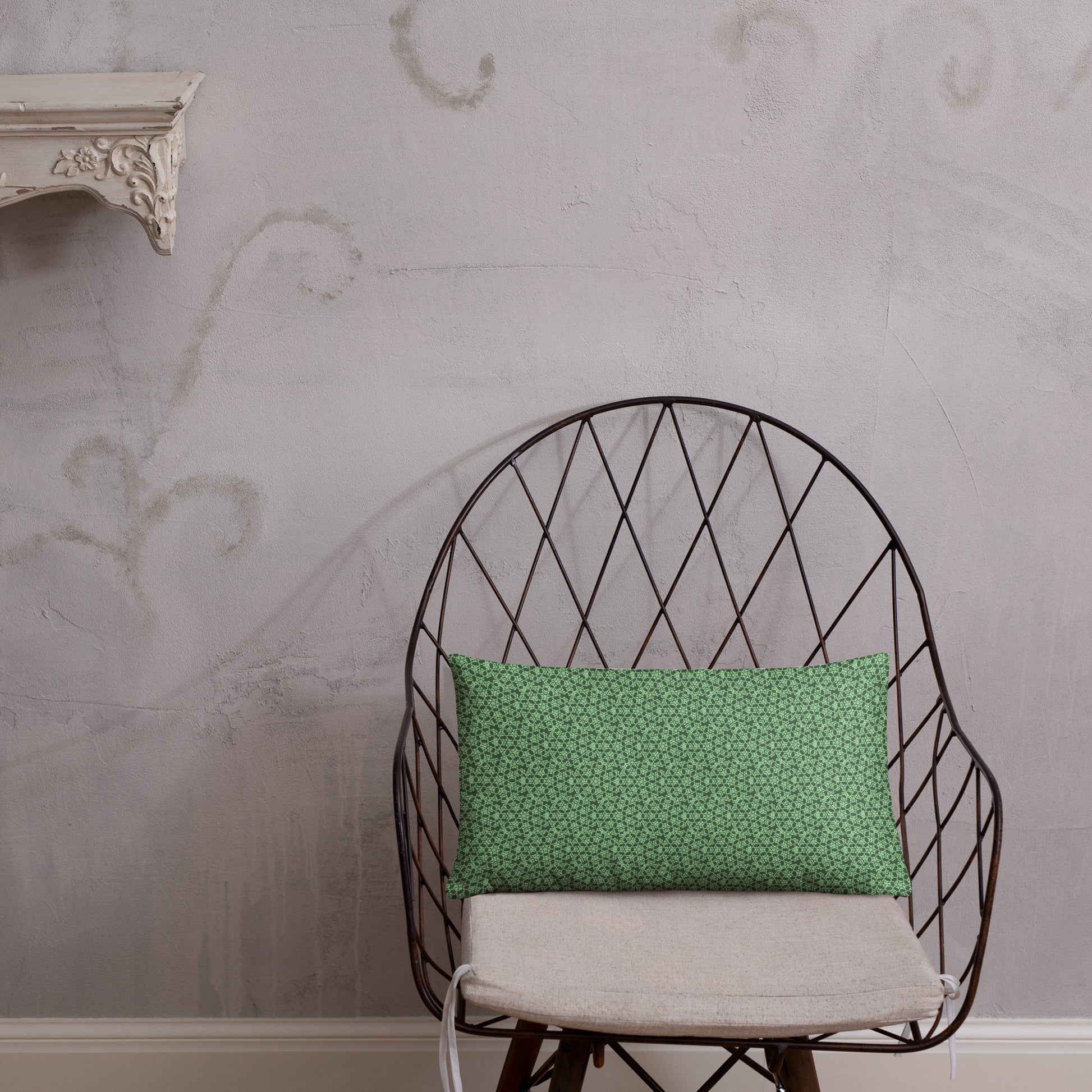 20″×12″ throw pillow with the 'Heptagon' green geometric pattern on a chair.