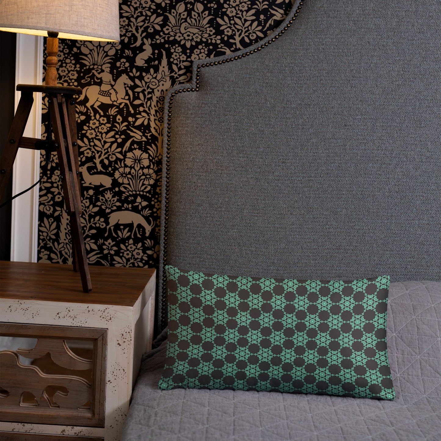 20″×12″ throw pillow with the 'Flowers Victory' charcoal and mint geometric pattern on a bed.