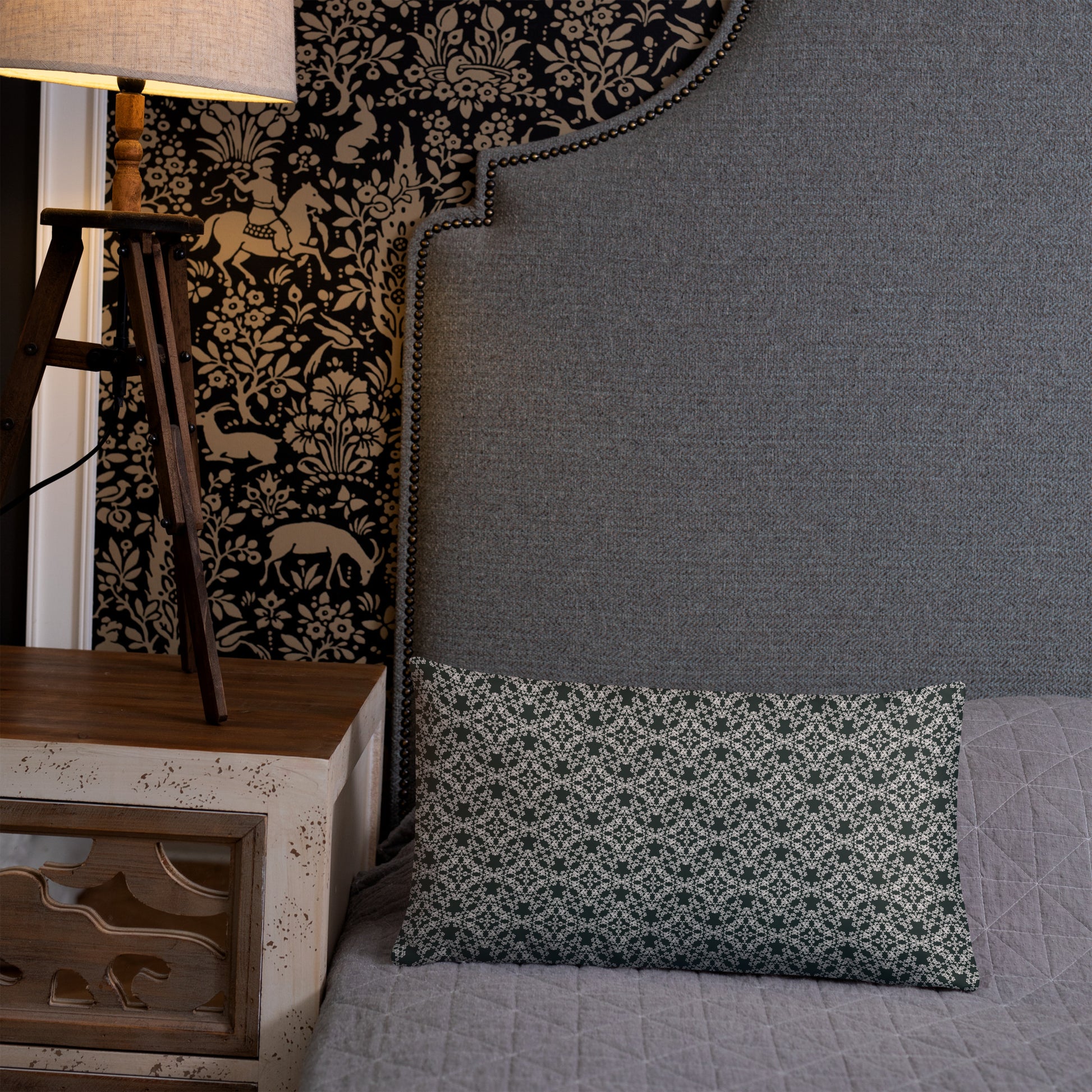 20″×12″ throw pillow with the 'Tetragon' charcoal and white geometric pattern on a bed.