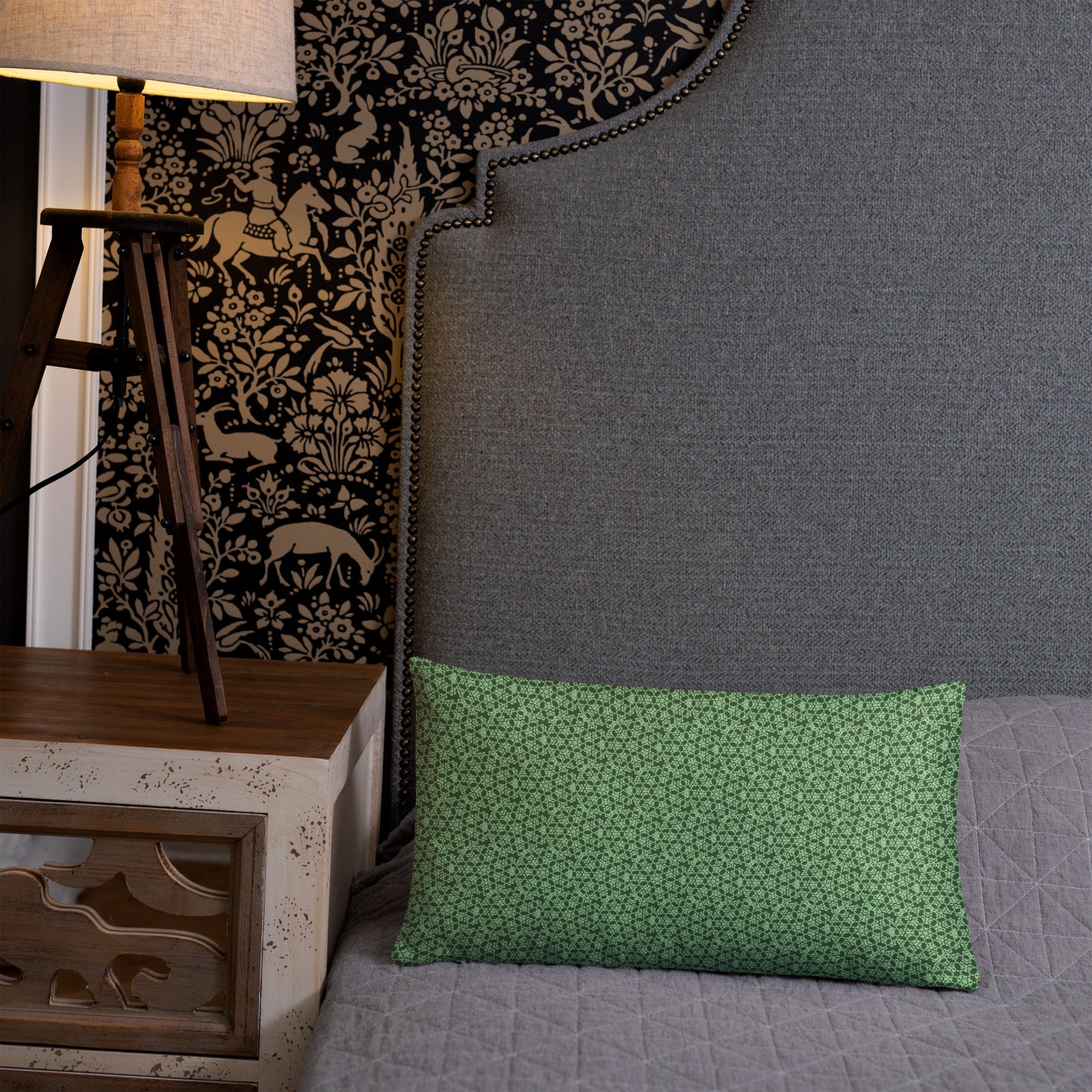 20″×12″ throw pillow with the 'Heptagon' green geometric pattern on a bed.