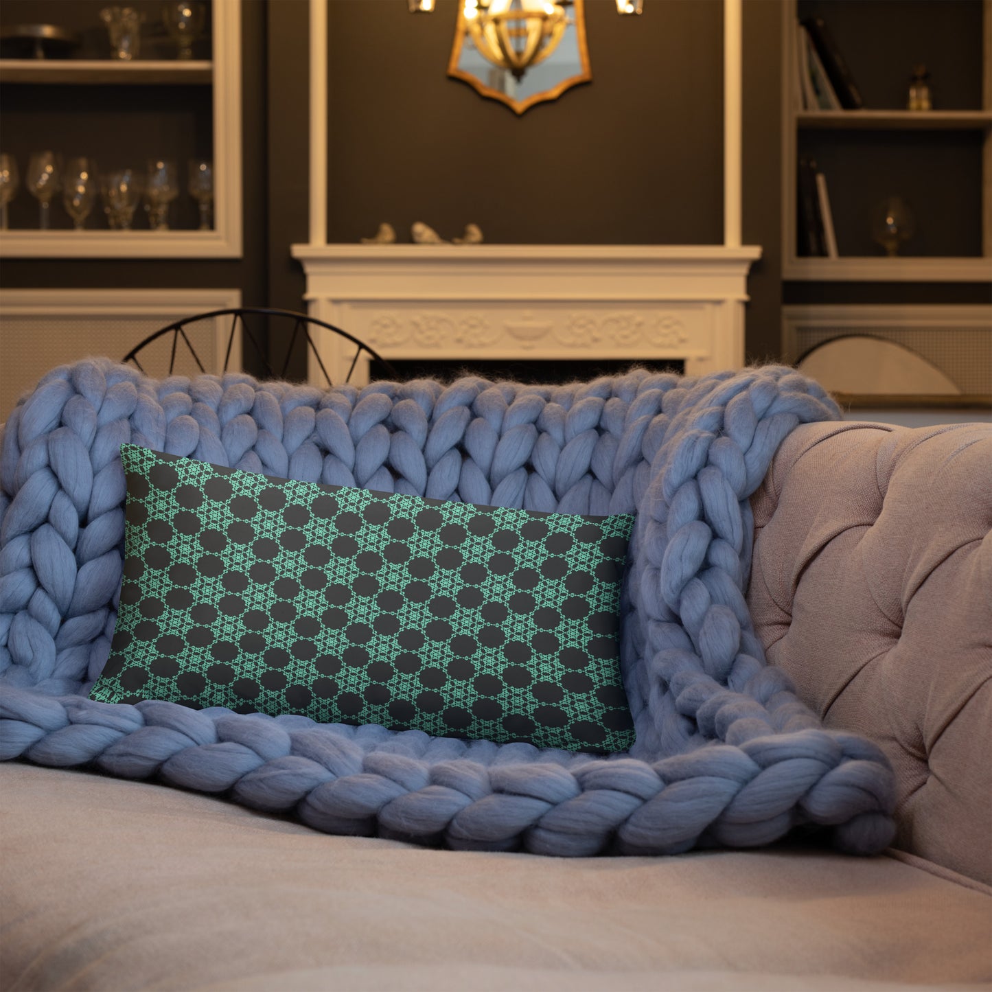 20″×12″ throw pillow with the 'Flowers Victory' charcoal and mint geometric pattern on a sofa.
