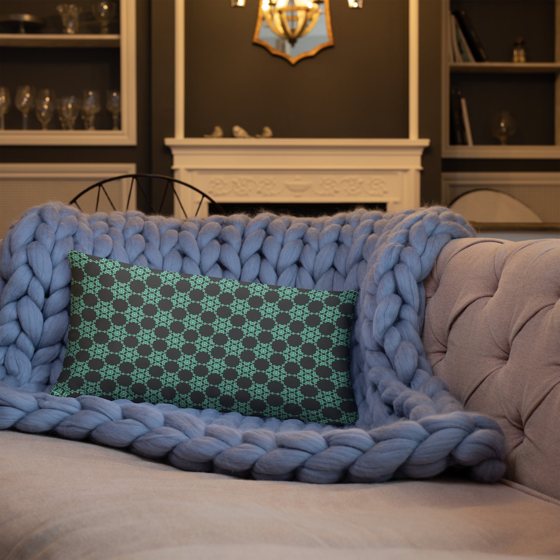 20″×12″ throw pillow with the 'Flowers Victory' charcoal and mint geometric pattern on a sofa.