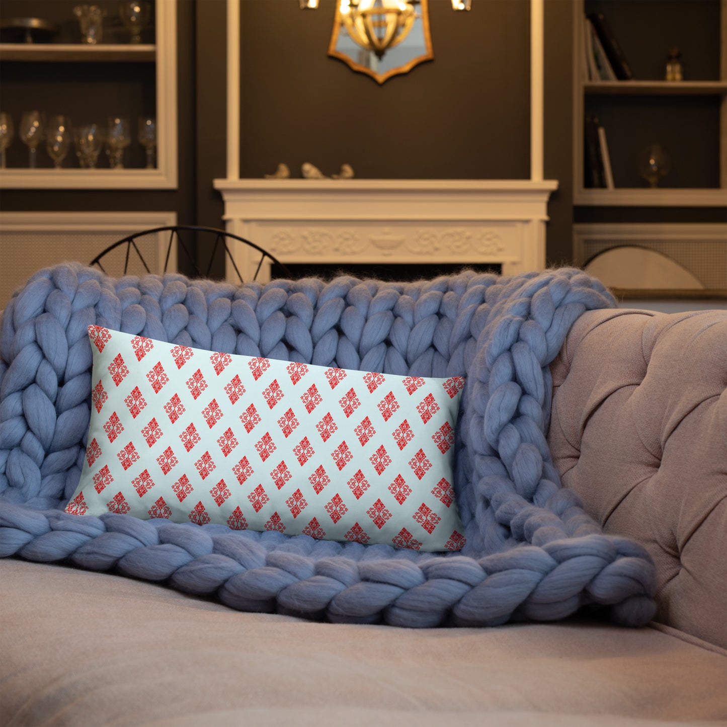 20″×12″ throw pillow with the 'Digon' sky blue and red geometric pattern on a sofa.