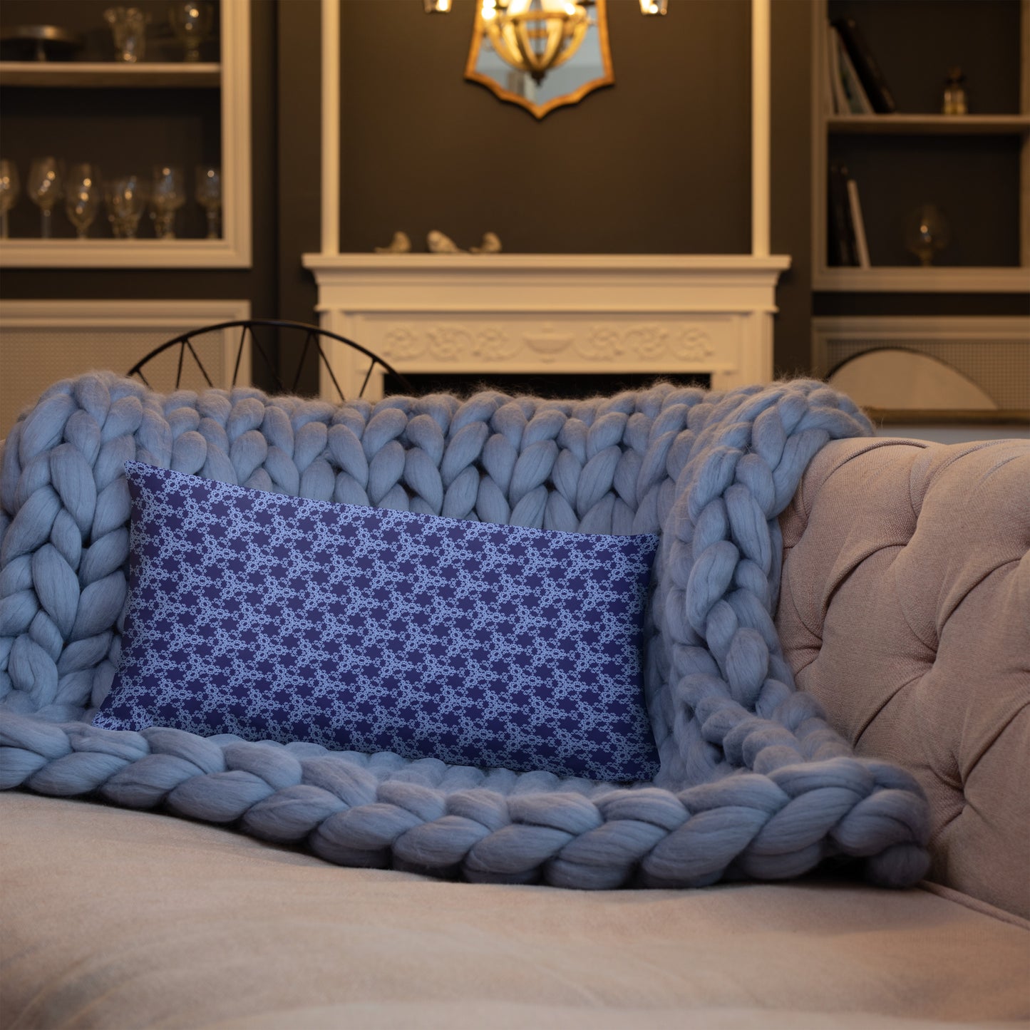 20″×12″ throw pillow with the 'Trigon' navy and blue geometric pattern on a sofa.