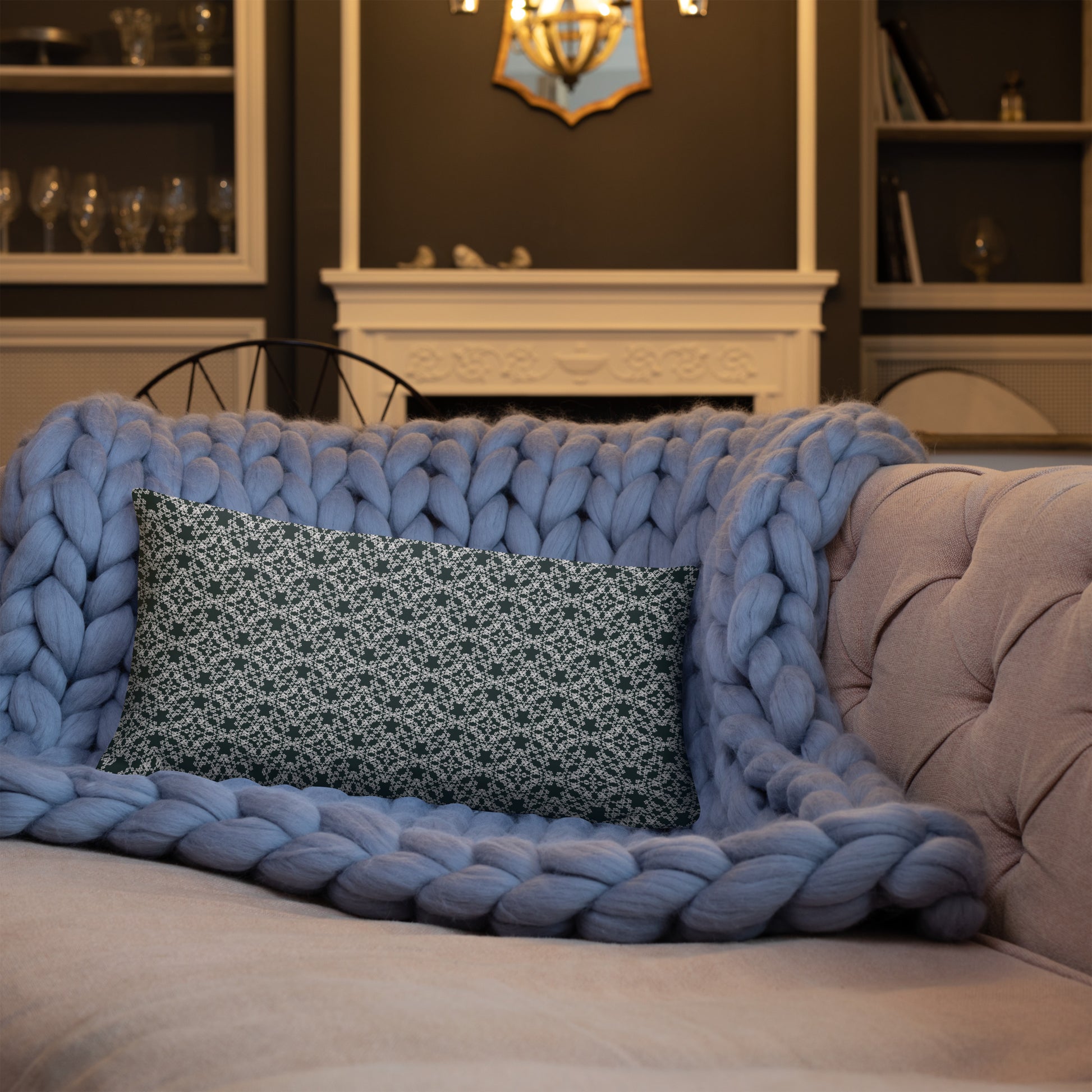 20″×12″ throw pillow with the 'Tetragon' charcoal and white geometric pattern on a sofa.